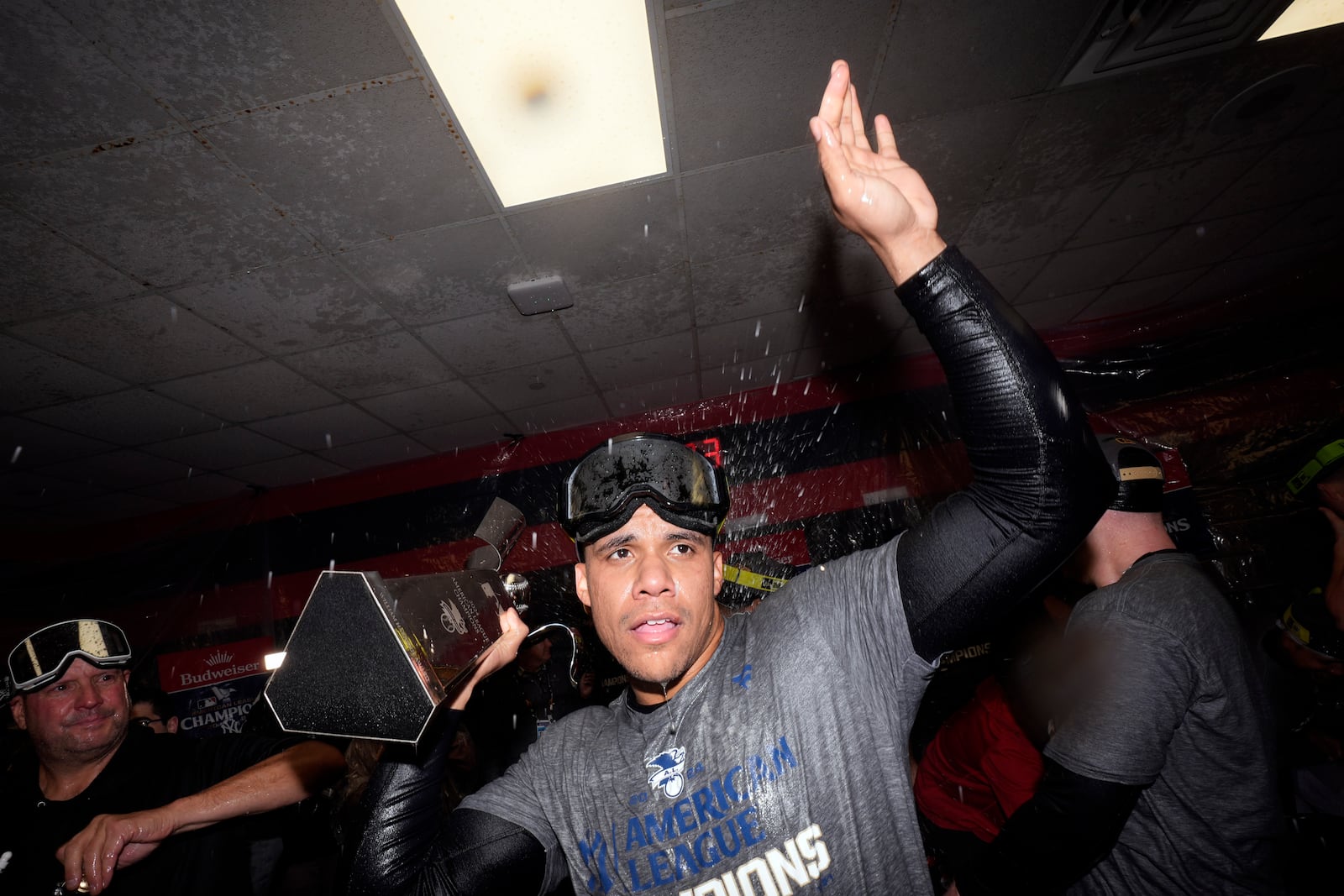 New York Yankees' Juan Soto celebrates in the clubhouse after Game 5 of the baseball AL Championship Series against the Cleveland Guardians Sunday, Oct. 20, 2024, in Cleveland. The Yankees won 5-2 to advance to the World Series. (AP Photo/Godofredo A. Vásquez )