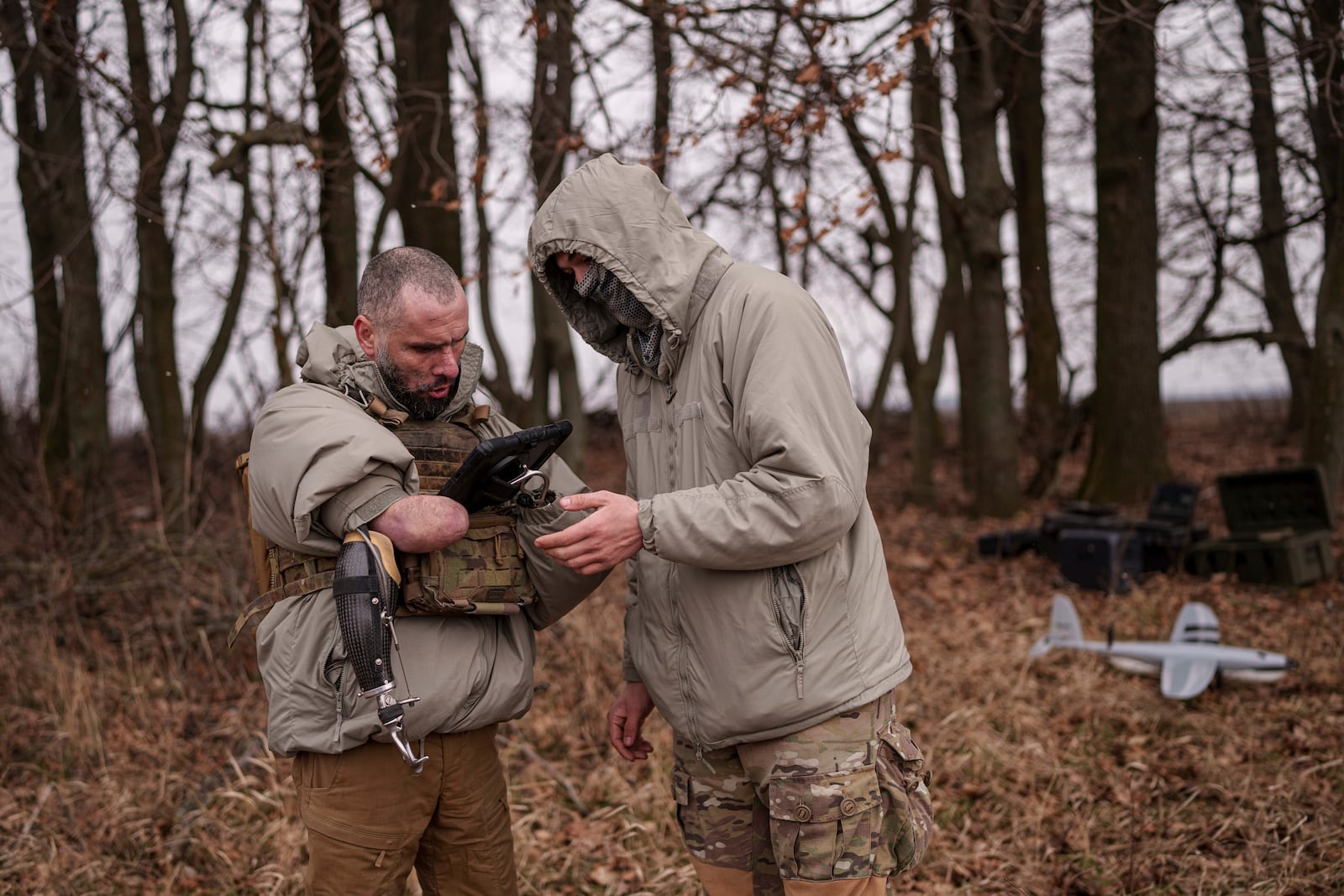 Andrii Rubliuk, a senior sergeant with a Ukrainian intelligence unit who lost both arms and a leg in combat, looks at a tablet during military training near Kyiv, Ukraine, on Feb. 14, 2025. (AP Photo/Evgeniy Maloletka)