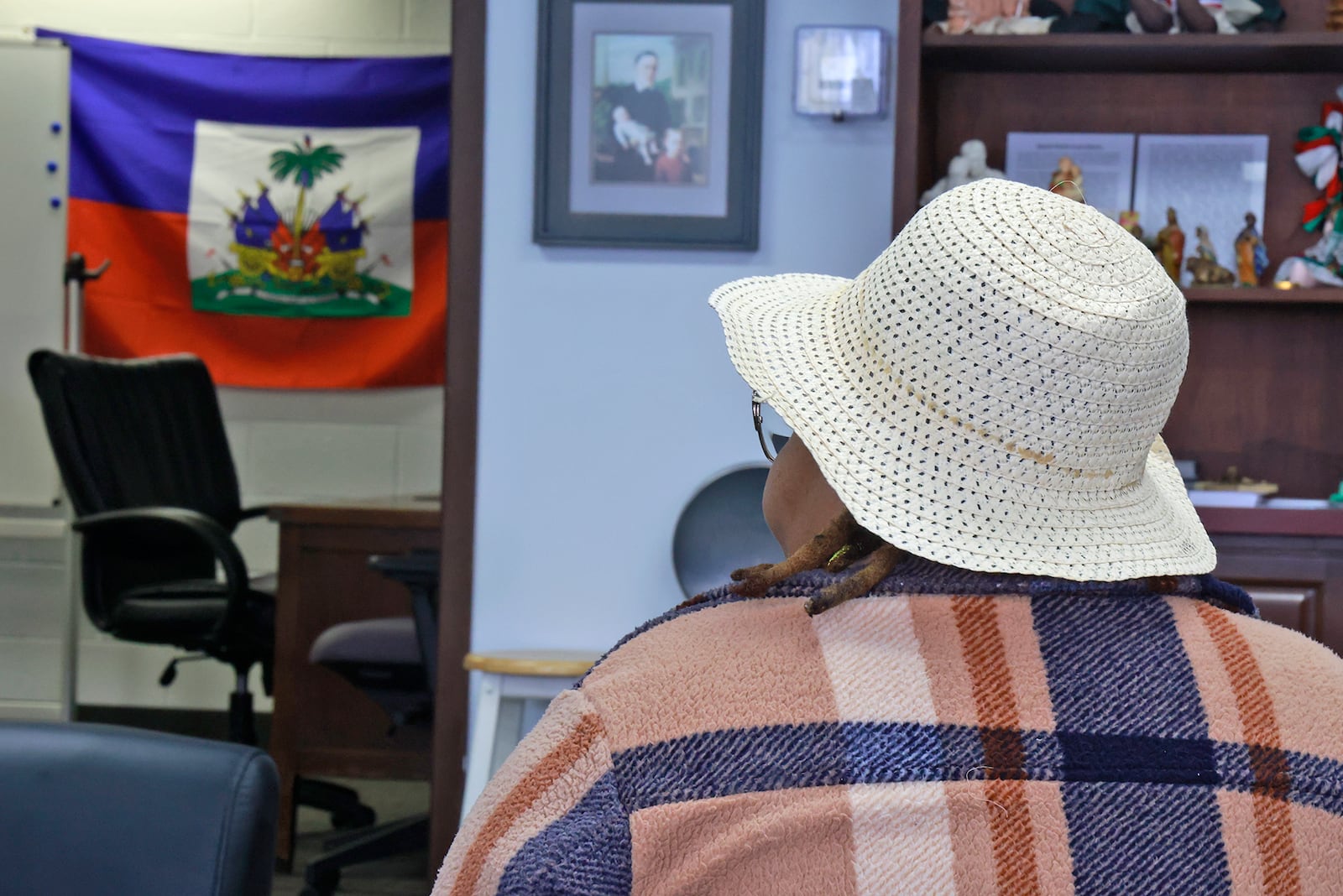 A woman from Haiti didn't want to be identified as she talks about her fears with Donald Trump winning the election. BILL LACKEY/STAFF