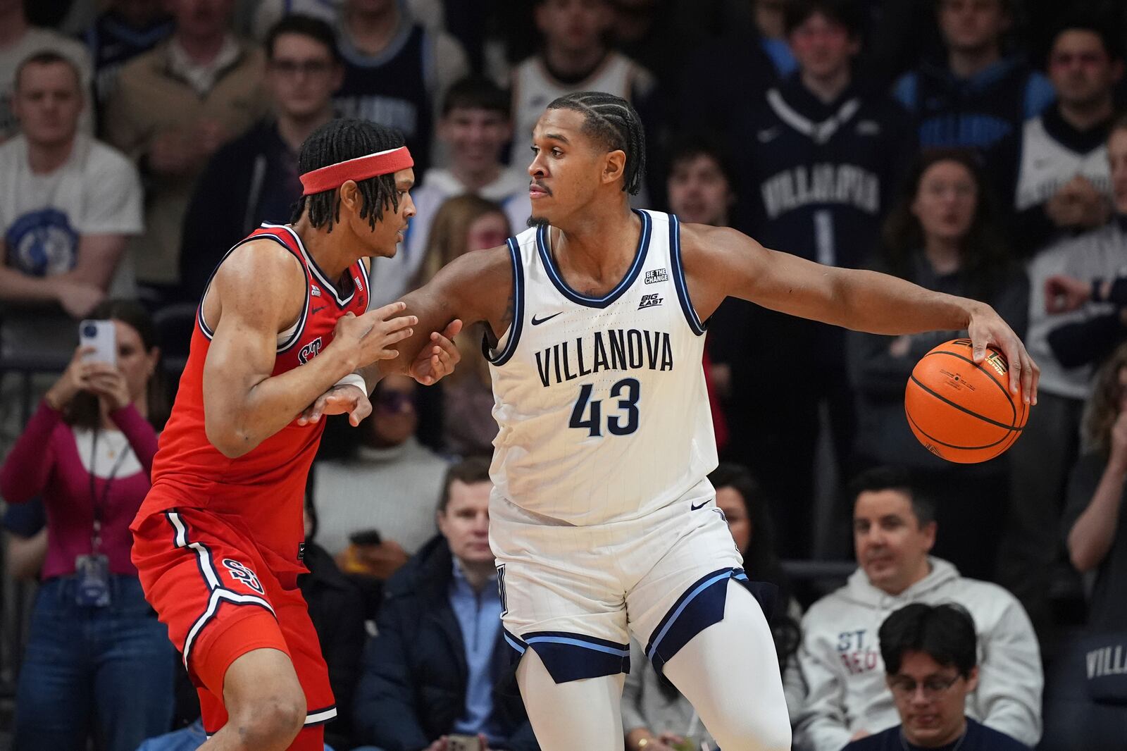 Villanova's Eric Dixon, right, tries to get past St. John's Aaron Scott during the first half of an NCAA college basketball game, Wednesday, Feb. 12, 2025, in Villanova, Pa. (AP Photo/Matt Slocum)