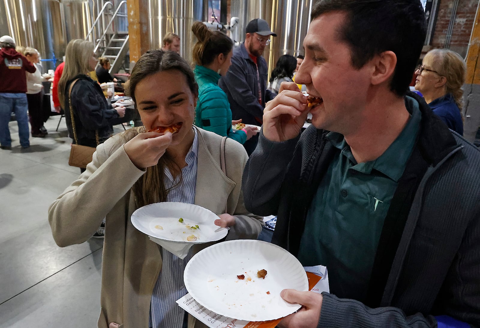 Zach and Madalyn Vaughn sample some of the pizza at the Slice of Springfield competition Thursday, Feb. 9, 2023 at Mother Stewart's Brewery. BILL LACKEY/STAFF