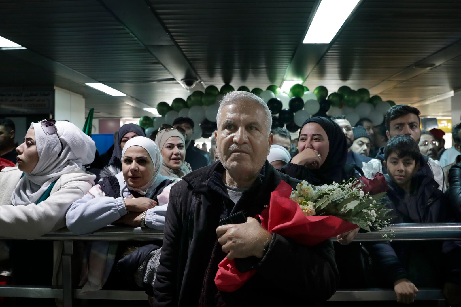 People wait to receive their relatives at the arrival terminal, after a first international commercial flight since the fall of former Syrian President Bashar Assad landed at Damascus international airport, in Damascus, Syria, Tuesday, Jan. 7, 2025. (AP Photo/Omar Sanadiki)