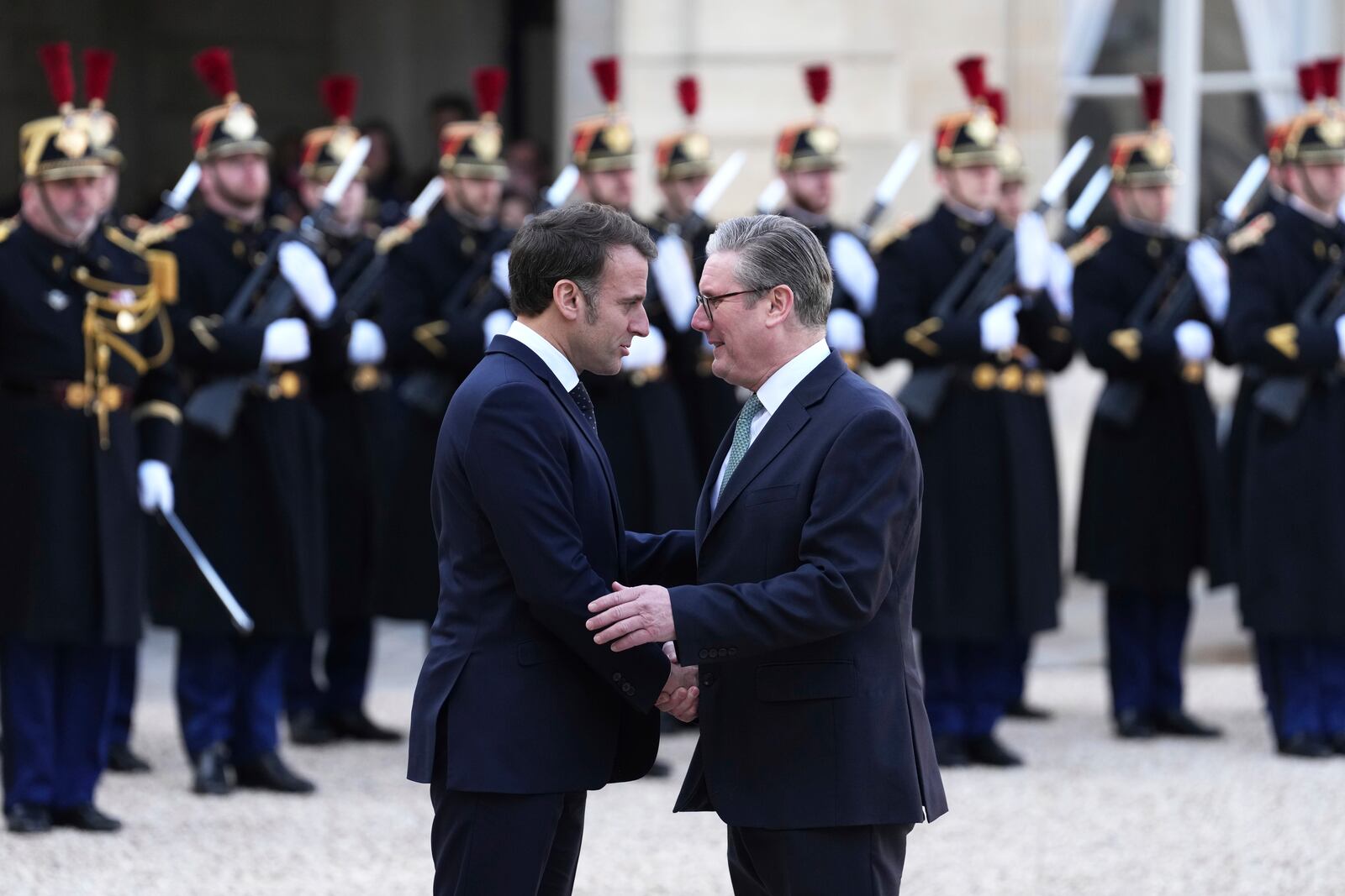 French President Emmanuel Macron, left, greets Britain's Prime Minister Keir Stammer as he arrives for an informal meeting of leaders from key European Union nations and the United Kingdom at the Elysee Palace in Paris, Monday, Feb. 17, 2025. (AP Photo/Aurelien Morissard)