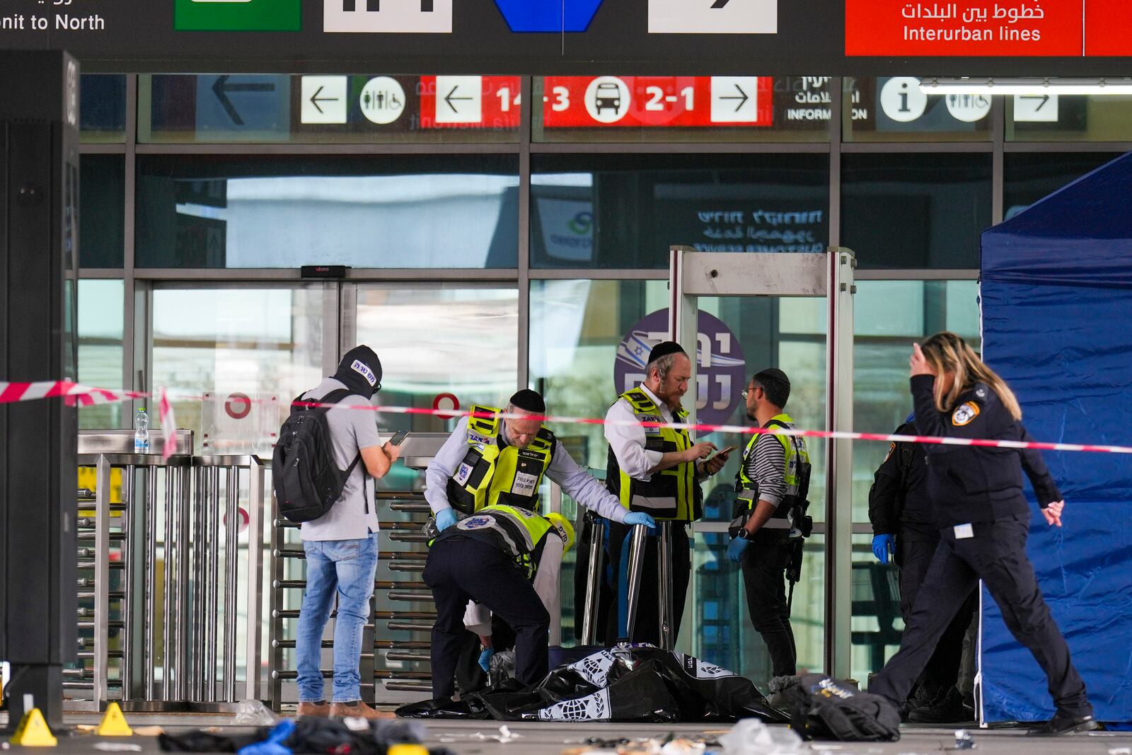 Israeli rescue and security forces examine the scene of a stabbing attack in Haifa, Israel, on Monday, March 30, 2025, where a 70-year-old man was killed and four others were injured. (AP Photo/Ariel Schalit)