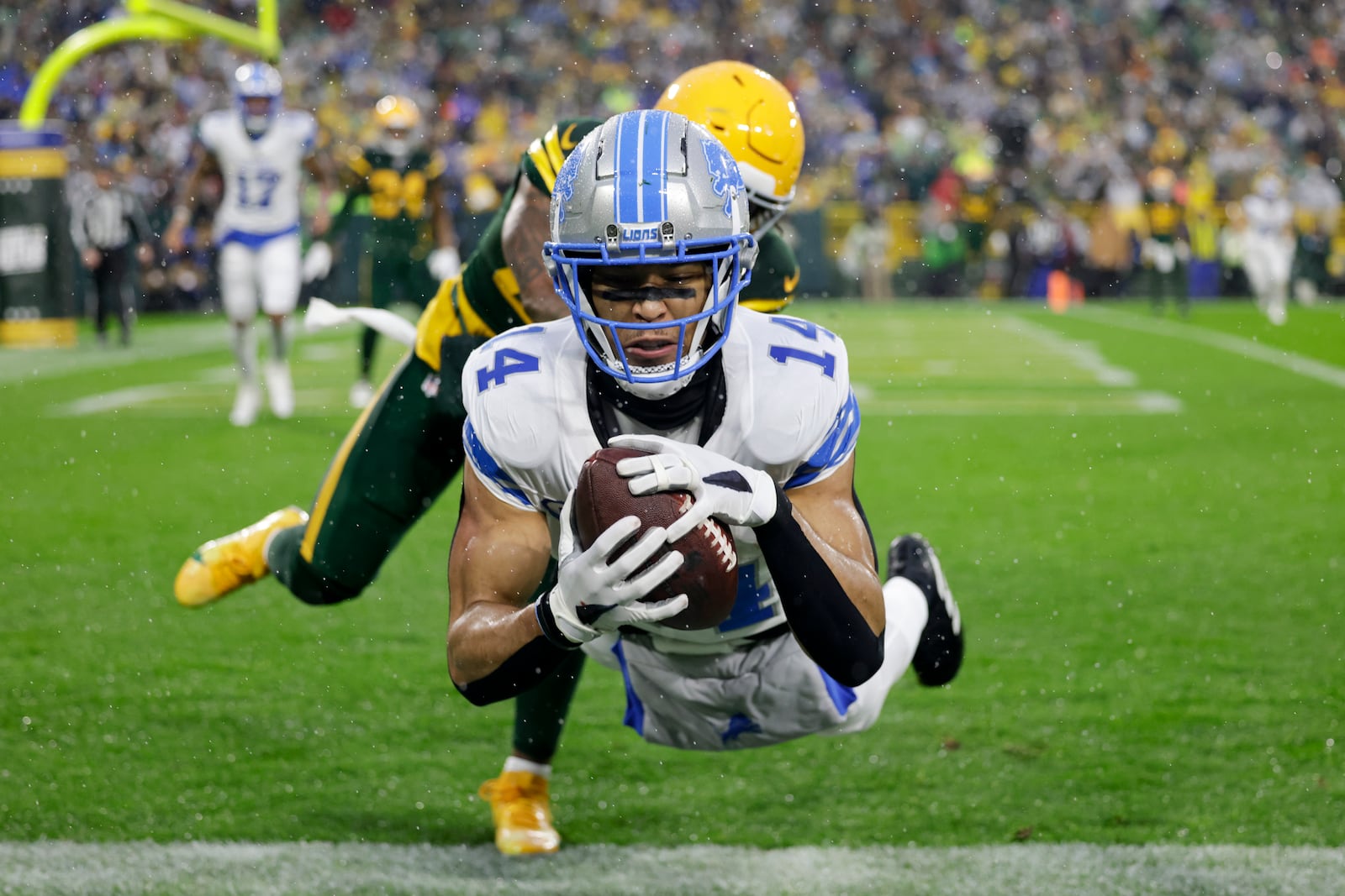 Detroit Lions wide receiver Amon-Ra St. Brown (14) catches a touchdown during the first half of an NFL football game against the Green Bay Packers, Sunday, Nov. 3, 2024, in Green Bay, Wis. (AP Photo/Matt Ludtke)