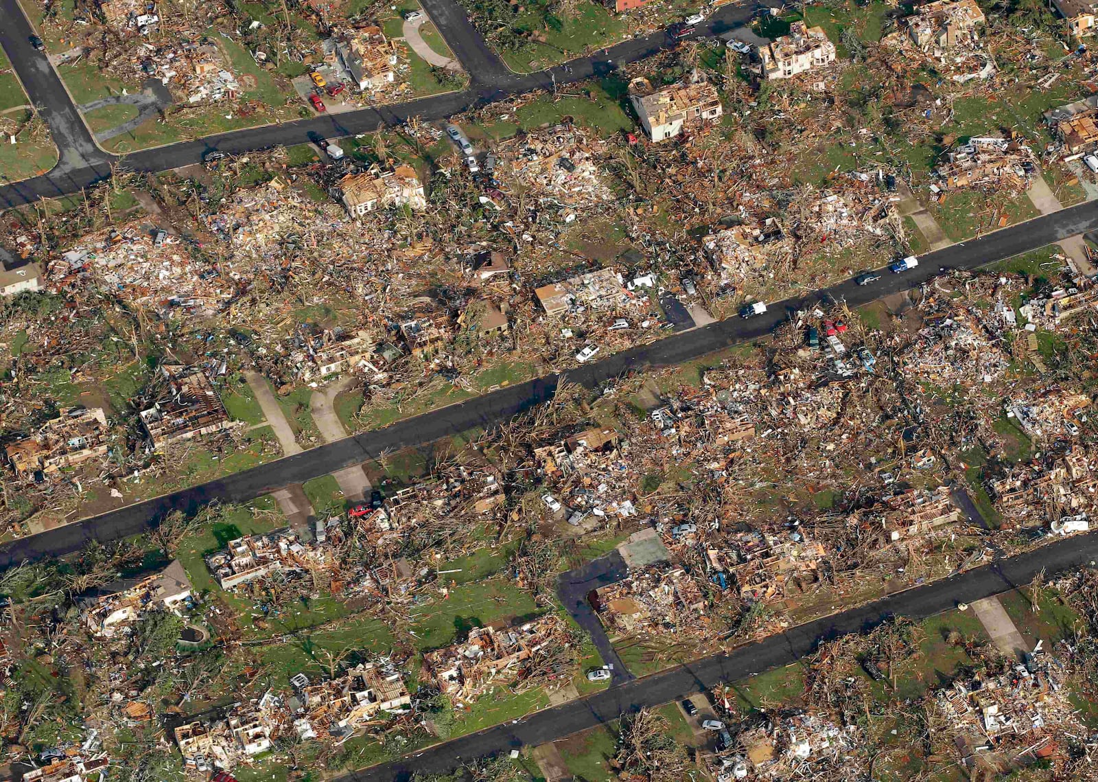 FILE- A destroyed neighborhood is seen in Joplin, Mo. Tuesday, May 24, 2011. (AP Photo/Charlie Riedel, File)