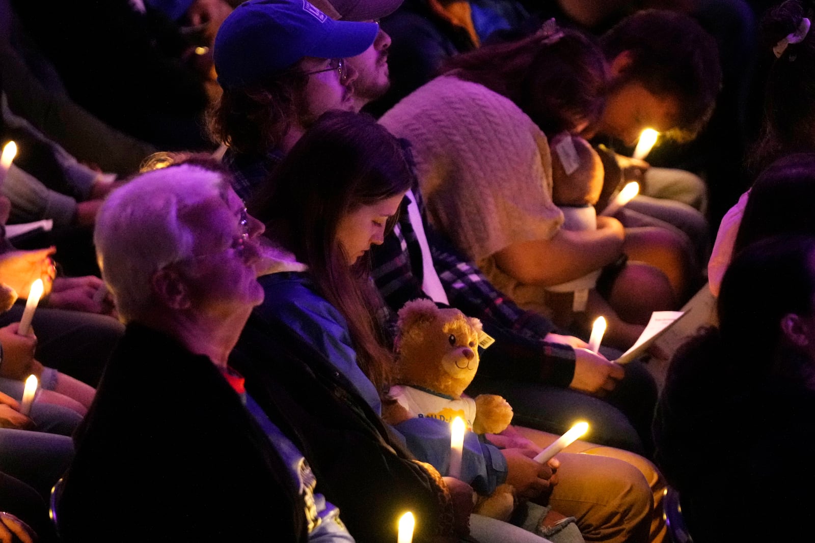 Attendees hold candle lights at a commemoration event to mark the one year anniversary of the mass shooting in Lewiston, Maine, Friday, Oct. 25, 2024. (AP Photo/Robert F. Bukaty)