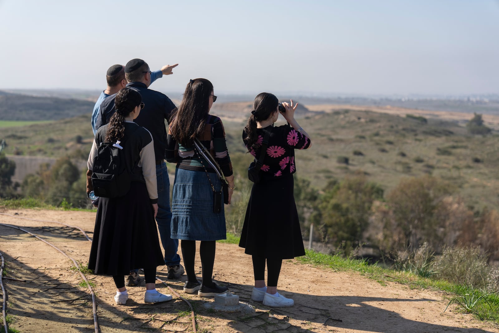 People watch the Gaza Strip from an observation point in Sderot, southern Israel, Monday, Jan. 13, 2025. (AP Photo/Ariel Schalit)