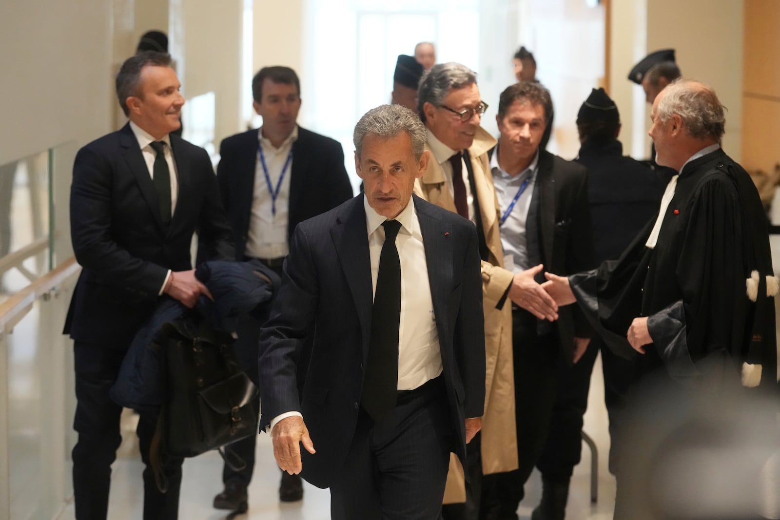 Former French President Nicolas Sarkozy arrives as he goes on trial over alleged illegal financing of his 2007 presidential campaign by the government of late Libyan leader Moammar Gadhafi, Monday, Jan. 6, 2025 in Paris. (AP Photo/Thibault Camus)