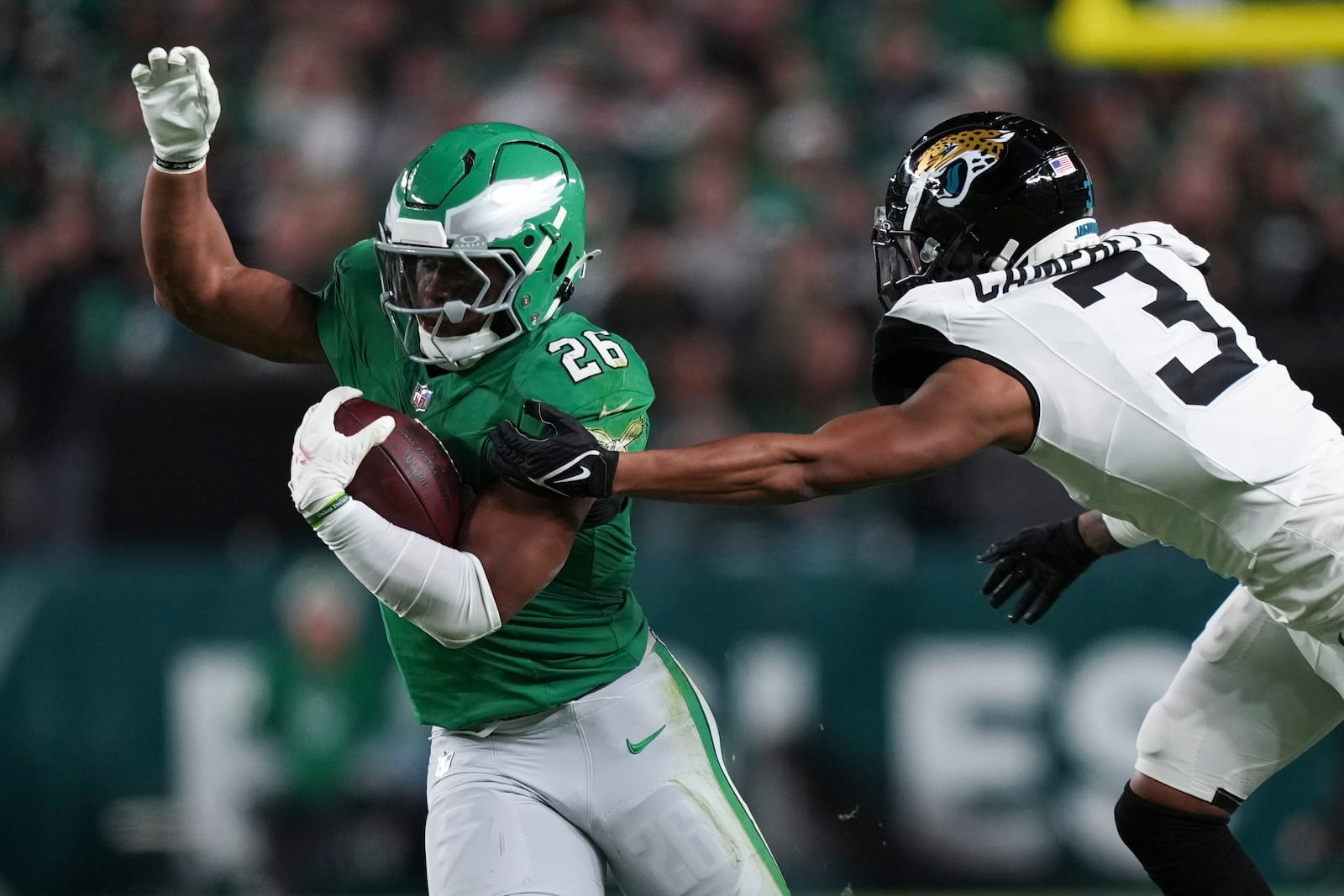 Philadelphia Eagles running back Saquon Barkley (26) is stopped by Jacksonville Jaguars cornerback Tyson Campbell (3) during the first half of an NFL football game Sunday, Nov. 3, 2024, in Philadelphia. (AP Photo/Matt Slocum)