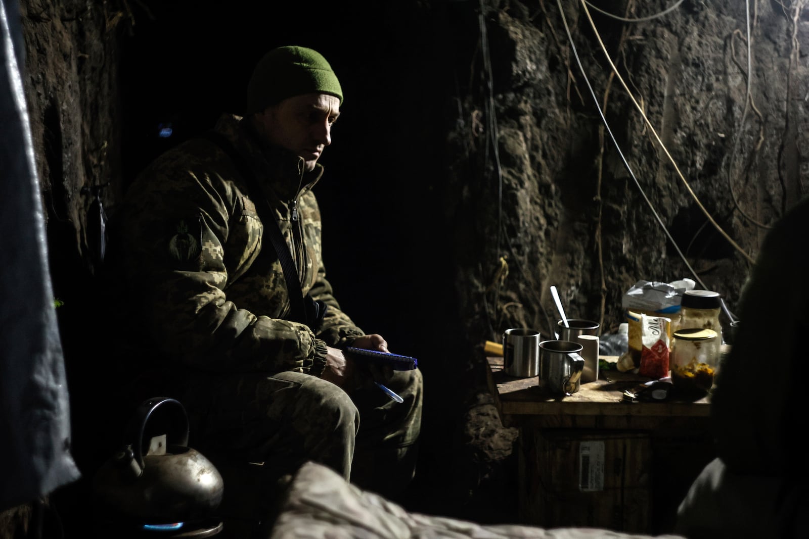 A Ukrainian serviceman sits in a shelter on his position at the frontline near Donetsk, Ukraine, Monday, March 3, 2025. (AP Photo/Roman Chop)