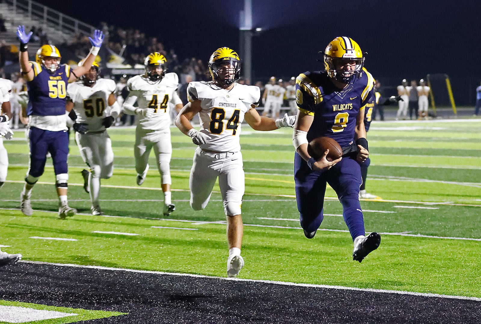 Springfield quarterback Bryce Schondelmyer leaps into the end zone to score a touchdown for the Wildcats during the playoff game against Centerville Friday. BILL LACKEY/STAFF