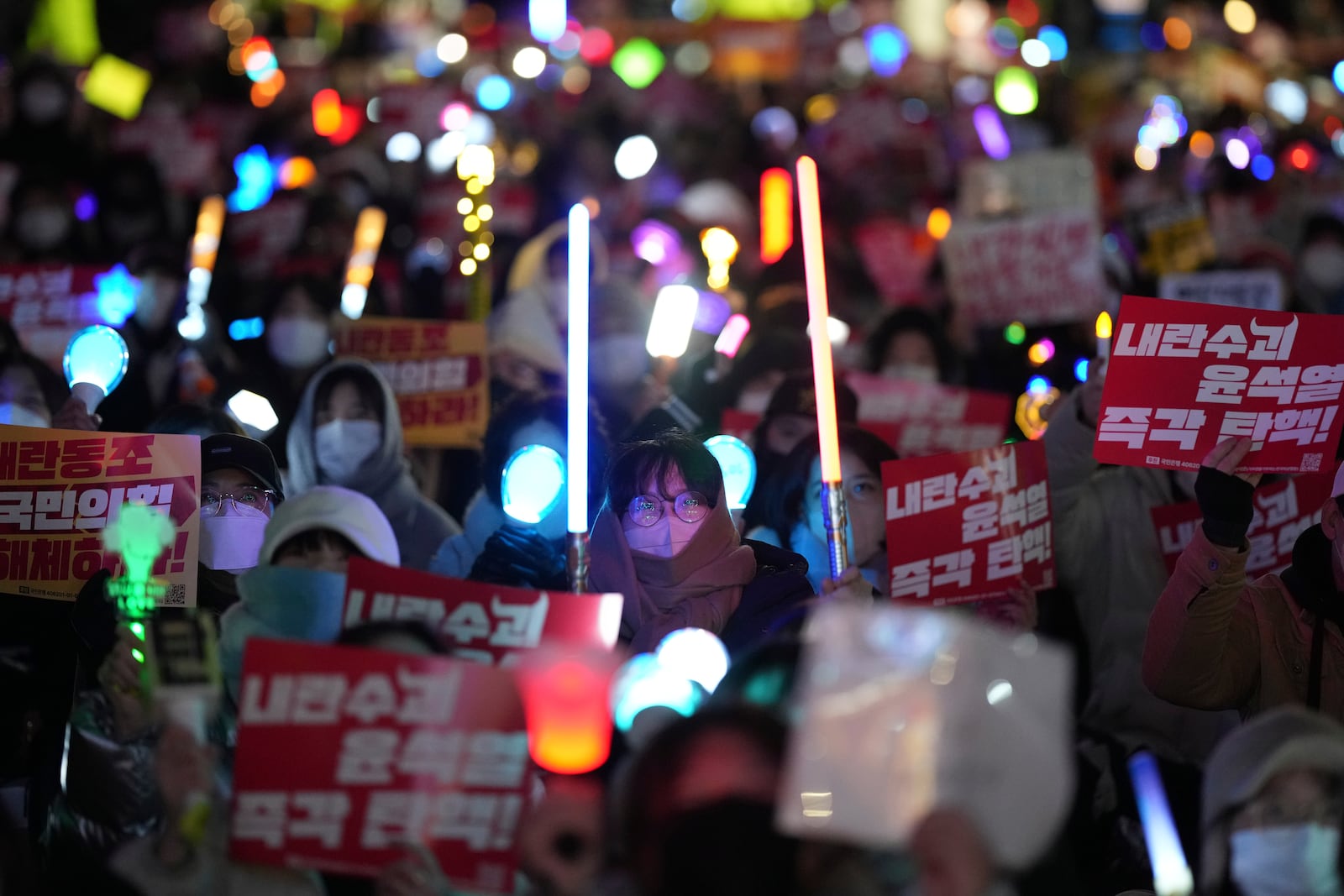 Participants gather to stage a rally demanding South Korean President Yoon Suk Yeol's impeachment, in front of the headquarters of the ruling People Power Party in Seoul, South Korea, Tuesday, Dec. 10, 2024. The banners read "Immediately impeachment Yoon Suk Yeol." (AP Photo/Lee Jin-man)