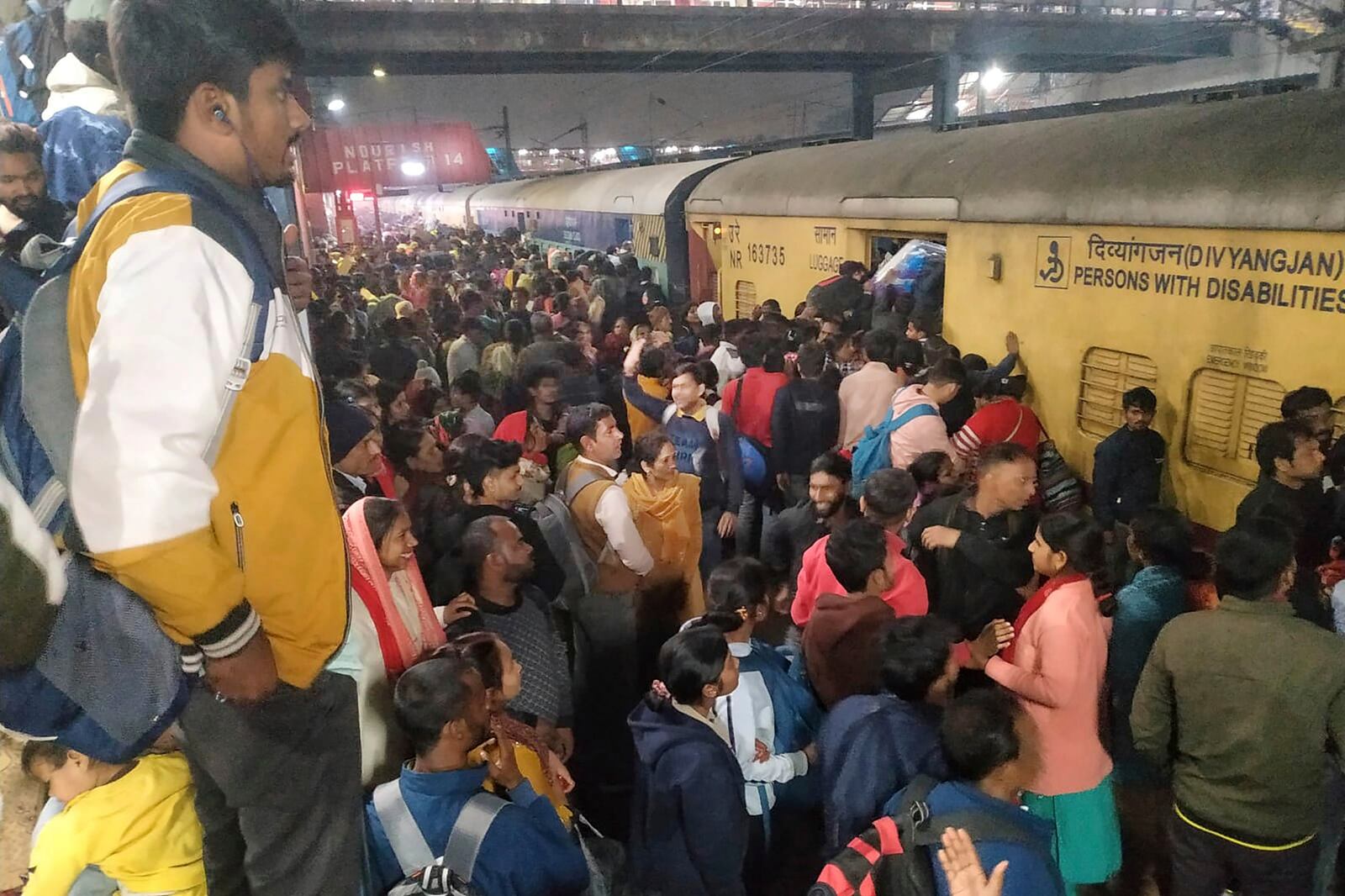 Passengers jostle with each other to board a train at the New Delhi Railway station, in New Delhi, India, Thursday, Feb.15, 2025. (AP Photo)