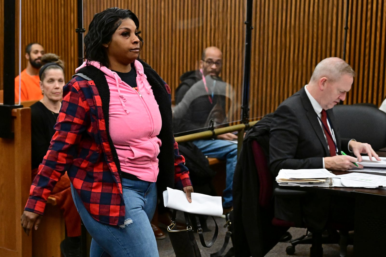 Fiona Allen walks toward the bench for her arraignment in Cuyahoga County Common Pleas Court, Tuesday, Dec. 3, 2024, in Cleveland. Allen is accused of illegally voting in five different elections since 2020. Though Allen is a legal resident of the United States, prosecutors say she is not an American citizen. (AP Photo/David Dermer)