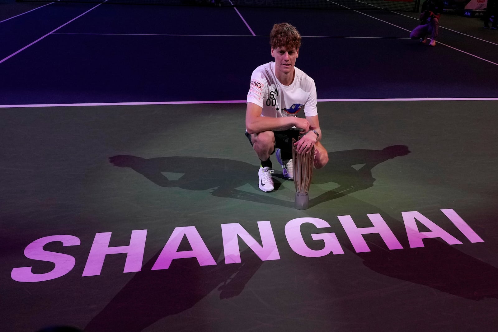 Jannik Sinner of Italy celebrates with his trophy after defeating Novak Djokovic of Serbia in the men's singles finals match for the Shanghai Masters tennis tournament at Qizhong Forest Sports City Tennis Center in Shanghai, China, Sunday, Oct. 13, 2024. (AP Photo/Andy Wong)