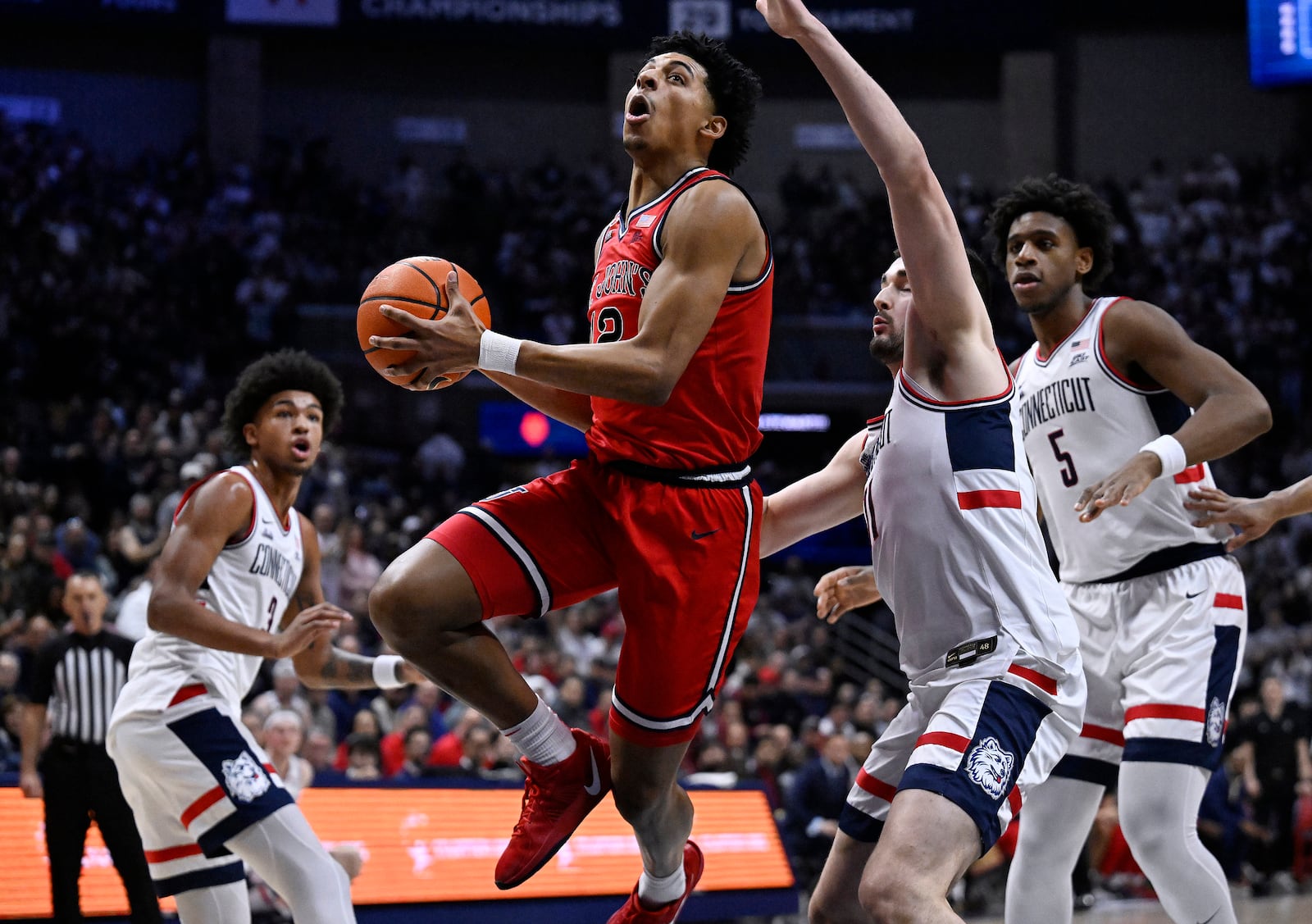 St. John's guard RJ Luis Jr., center, rises to the basket as UConn forward Alex Karaban, second from right, defends in the first half of an NCAA college basketball game, Friday, Feb. 7, 2025, in Storrs, Conn. (AP Photo/Jessica Hill)