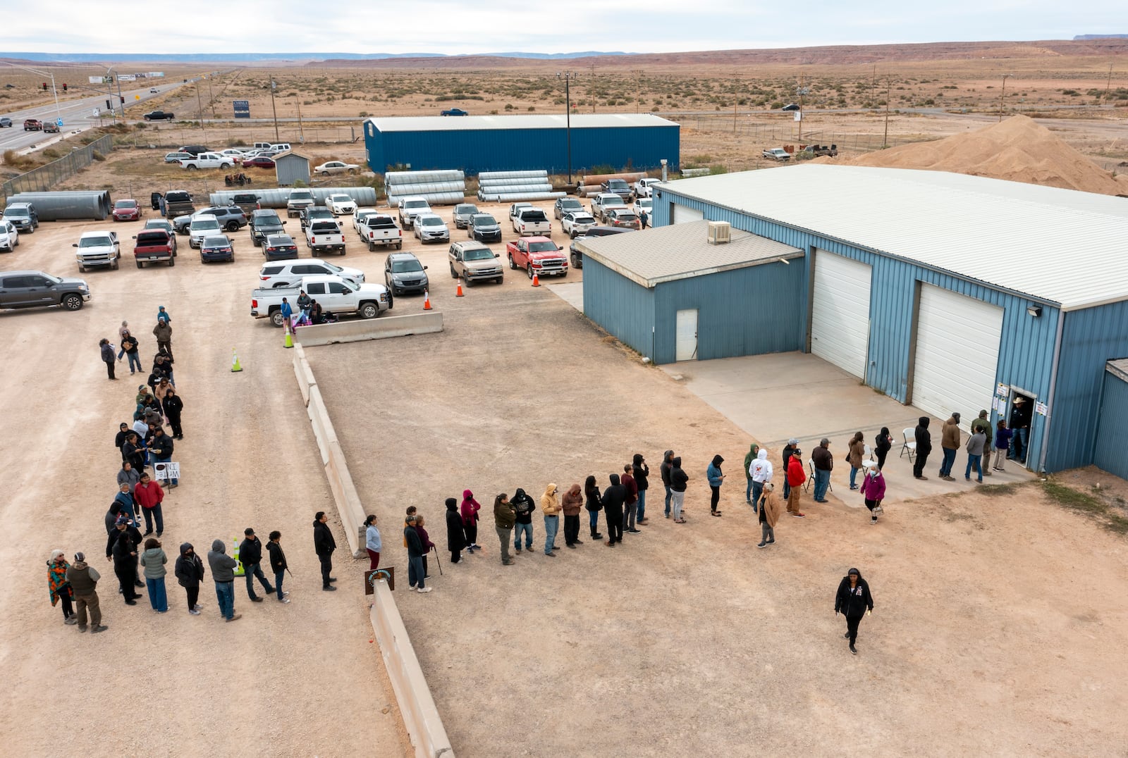 Voters wait in line to cast their ballots outside a polling station on the Navajo Nation in Chinle, Ariz., on Election Day, Tuesday, Nov. 5, 2024. (AP Photo/Andres Leighton)