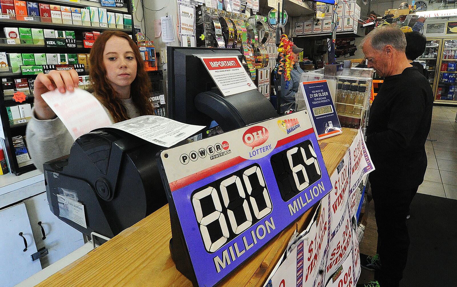 Haley Secrest, an empolyee of Bee-Gee's Market in Kettering stayed busy selling Powerball tickets Thursday Oct. 27, 2022. MARSHALL GORBY\STAFF