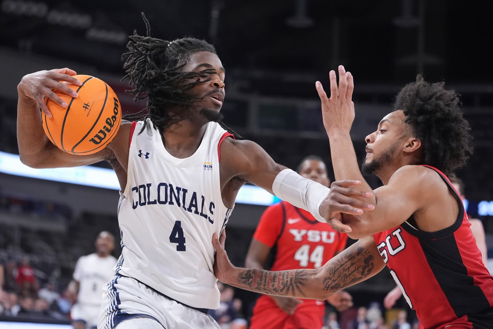 Robert Morris guard Josh Omojafo (4) holds off Youngstown State guard Jason Nelson (0) in the first half of an NCAA college basketball game in the championship of the Horizon League tournament in Indianapolis, Tuesday, March 11, 2025. (AP Photo/Michael Conroy)