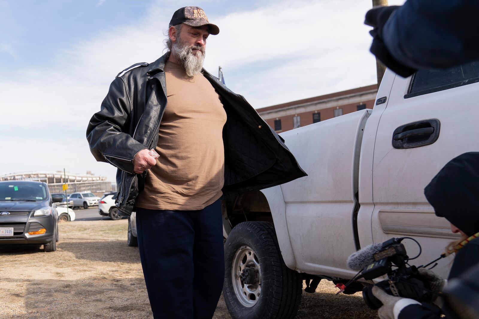 Supporter of President Donald Trump, William Sarsfield III, who was convicted for participating in the Jan. 6 riot at the U.S. Capitol, talks to reporters after being pardoned and released in the early morning hours from the Philadelphia Federal Detention Center before traveling to Washington, Tuesday, Jan. 21, 2025. (AP Photo/Jose Luis Magana)