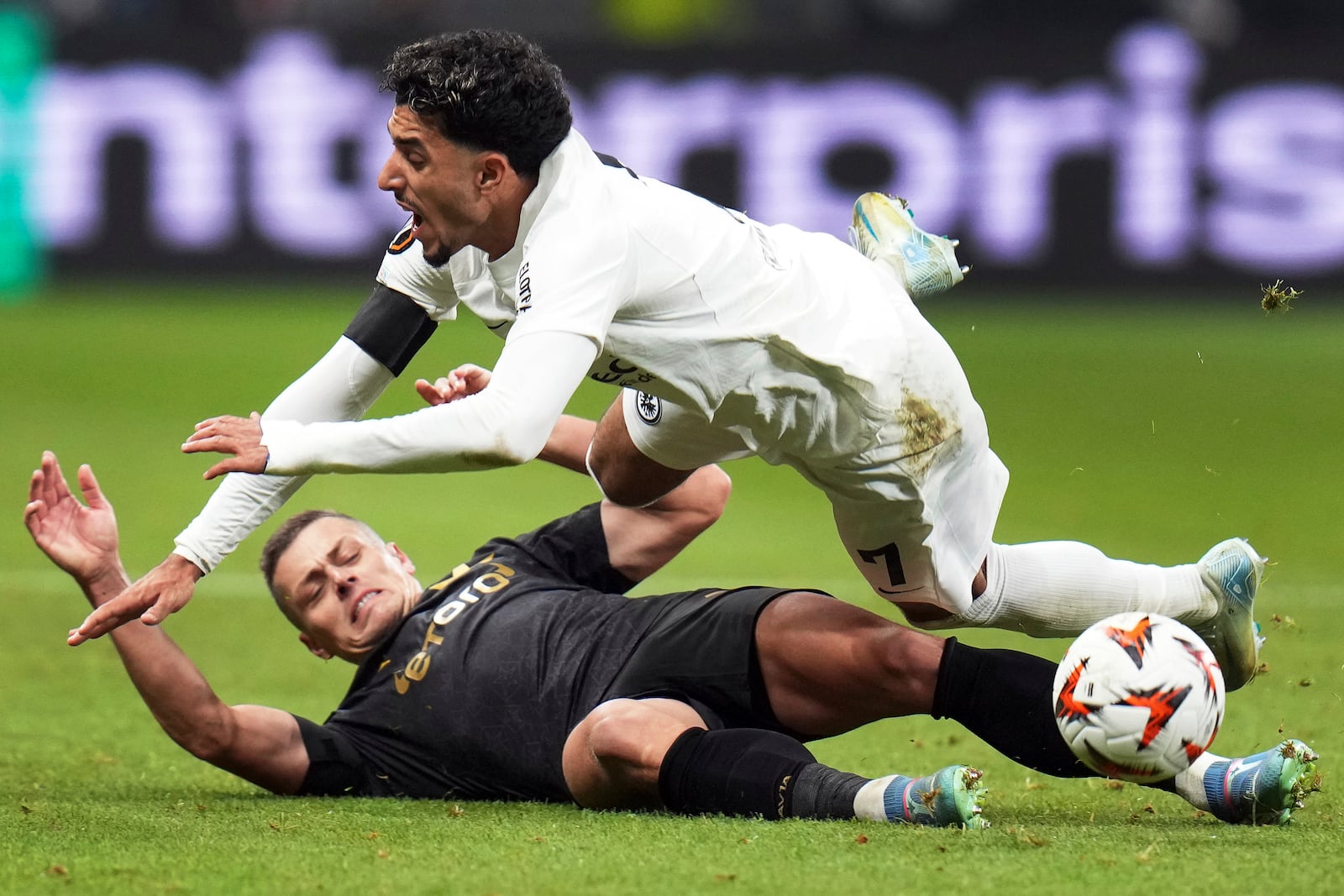 Prague's Tomas Holes, bottom, and Frankfurt's Omar Marmoush, top, challenge for the ball during the Europa League opening phase soccer match between Eintracht Frankfurt and Slavia Prague in Frankfurt, Germany, Thursday, Nov. 7, 2024. (Thomas Frey/dpa via AP)