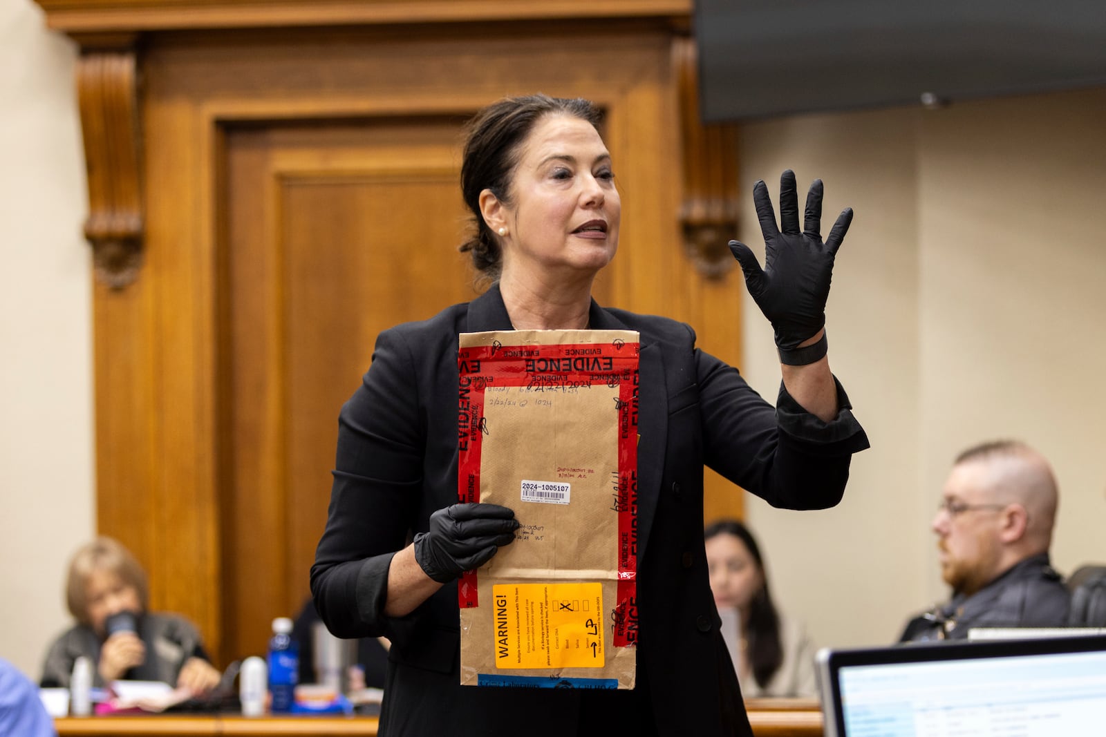 Prosecutor Sheila Ross speaks while holding an evidence bag during the trial for Jose Ibarra at the Athens-Clarke County Superior Court on Monday, Nov. 18, 2024, in Athens, Ga. (Arvin Temkar/Atlanta Journal-Constitution via AP, Pool)