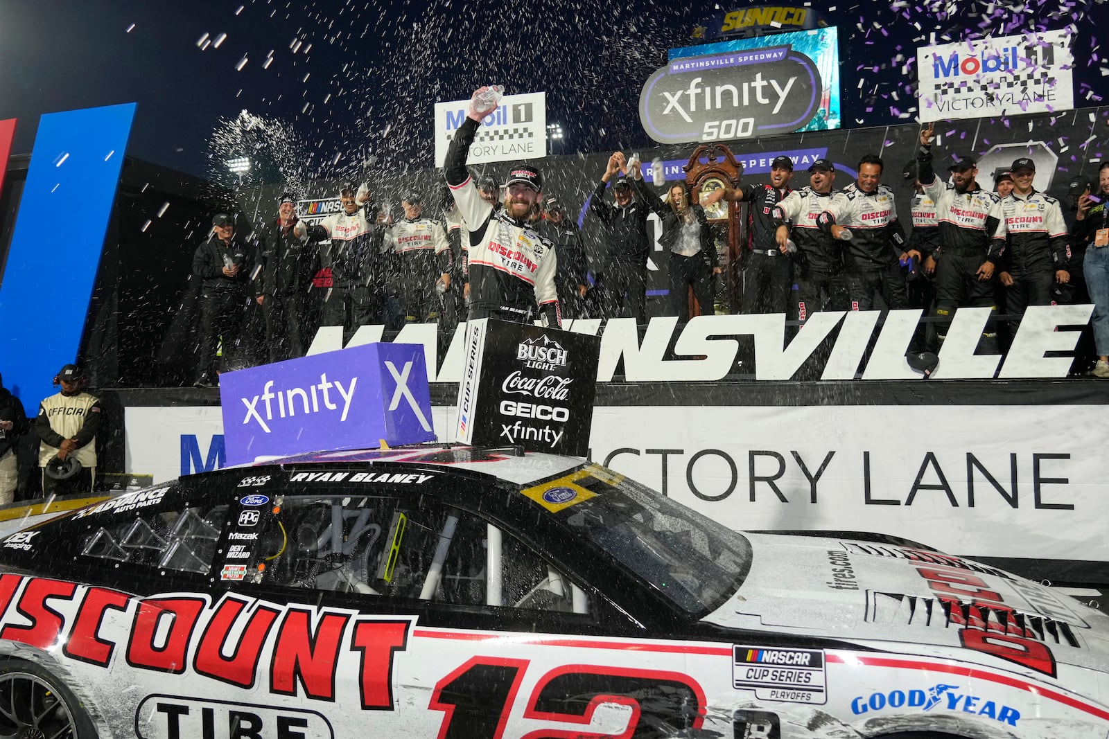 Ryan Blaney, center, celebrates in Victory Lane after winning a NASCAR Cup Series auto race at Martinsville Speedway in Martinsville, Va., Sunday, Nov. 3, 2024. (AP Photo/Chuck Burton)