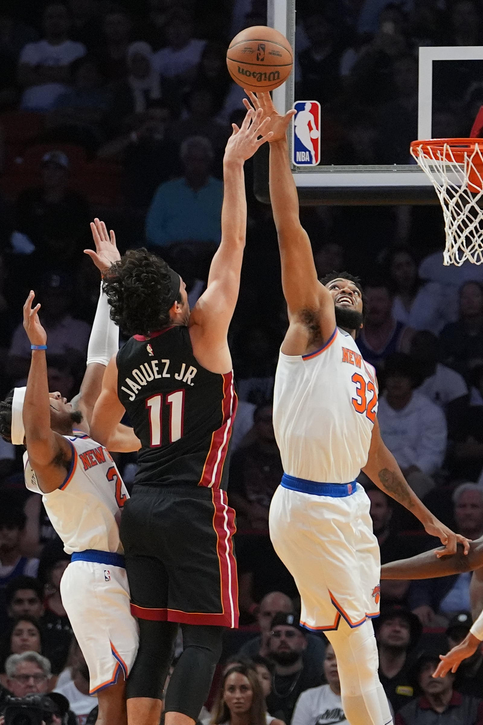 Miami Heat guard Jaime Jaquez Jr. (11) shoots as New York Knicks center Karl-Anthony Towns (32) defends during the first half of an NBA basketball game, Wednesday, Oct. 30, 2024, in Miami. (AP Photo/Lynne Sladky)