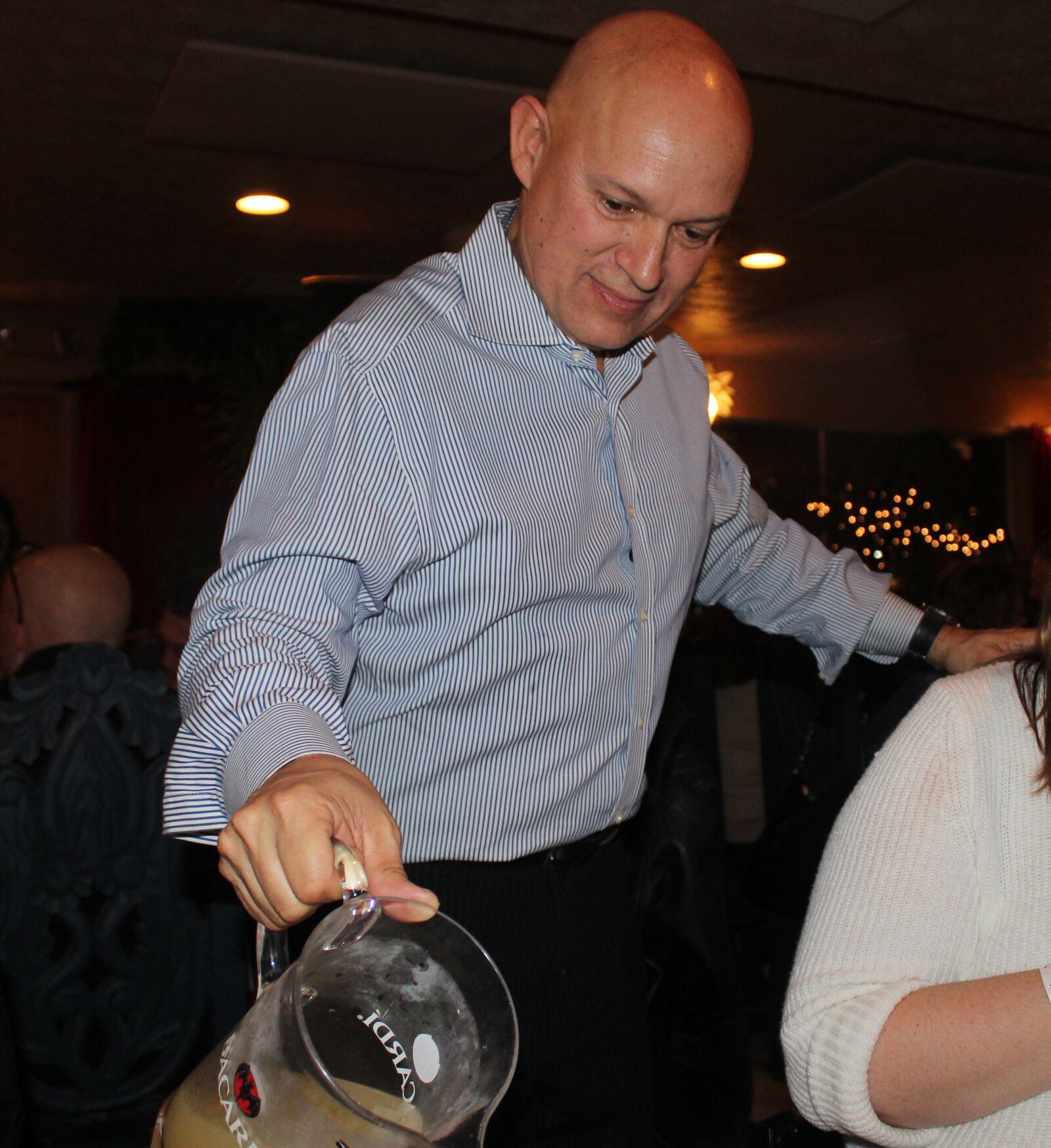 Bill Castro pours drinks  during a recent event at El Meson, his family's restaurant.