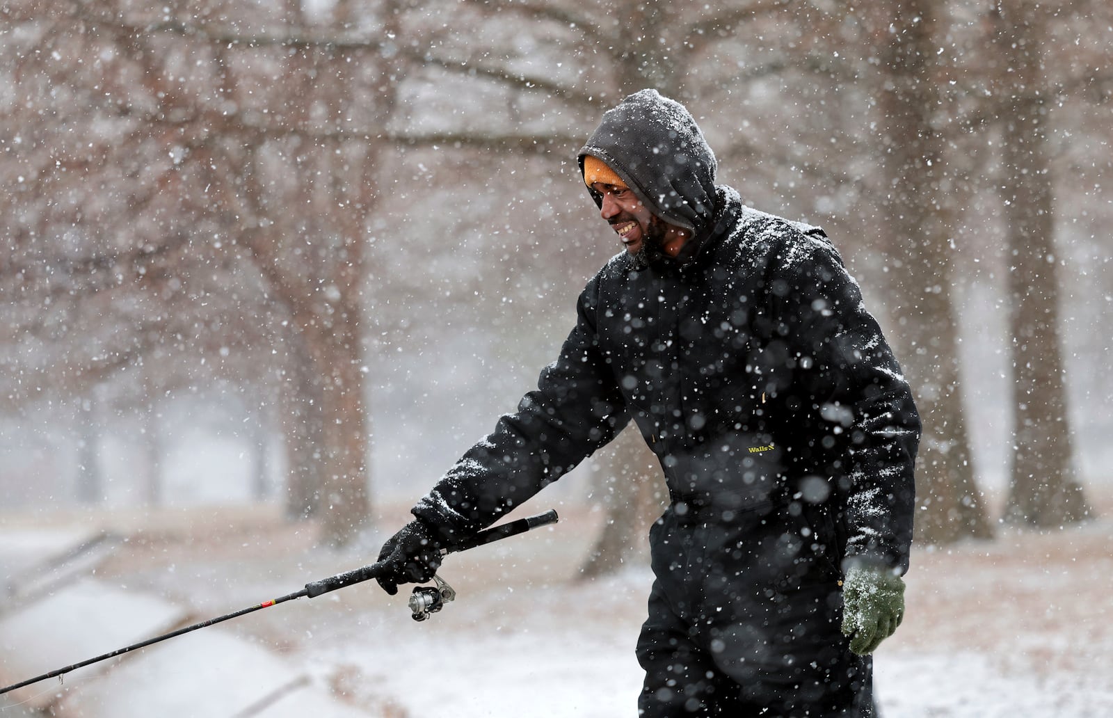 "Sometimes this is the best time to fish," said Ray King as he fishes for trout during a steady snowfall at the lake in O'Fallon Park in St. Louis, Mo., Wednesday, Feb. 12, 2025. (Robert Cohen/St. Louis Post-Dispatch via AP)