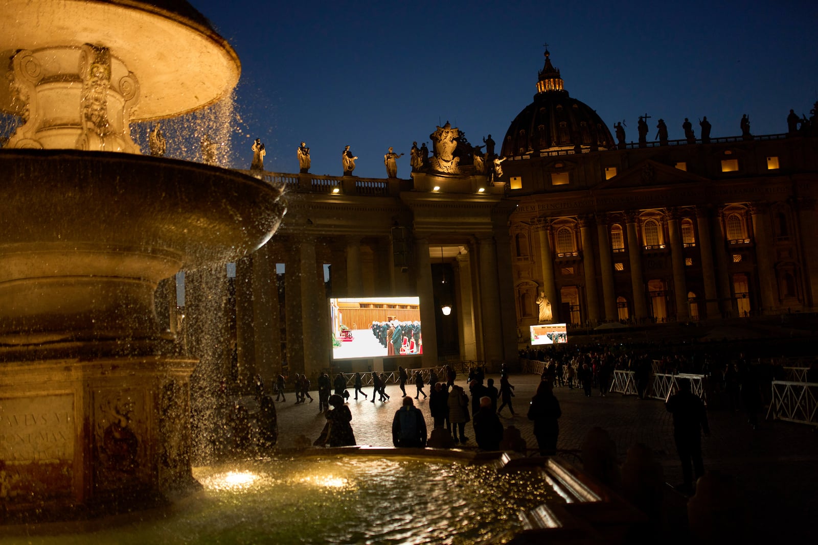 People watch on a big screen a live broadcasted Rosary prayer for Pope Francis, in St. Peter's Square at the Vatican, Tuesday, March 11, 2025. (AP Photo/Francisco Seco)