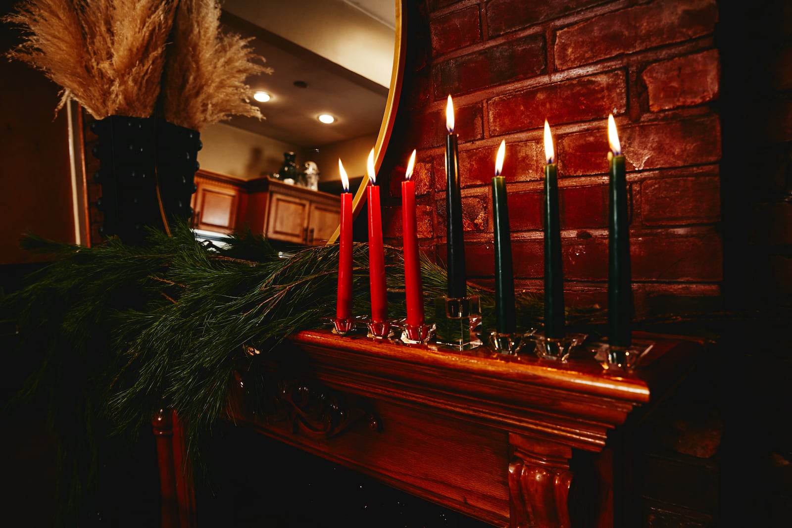 The kinara, or candleholder, on the mantle of Krystal Stark and Kerry Coddett, in New York, Dec. 11, 2020. The seven candles (red, black and green) represent the seven Kwanzaa values. (Timothy Smith/The New York Times)