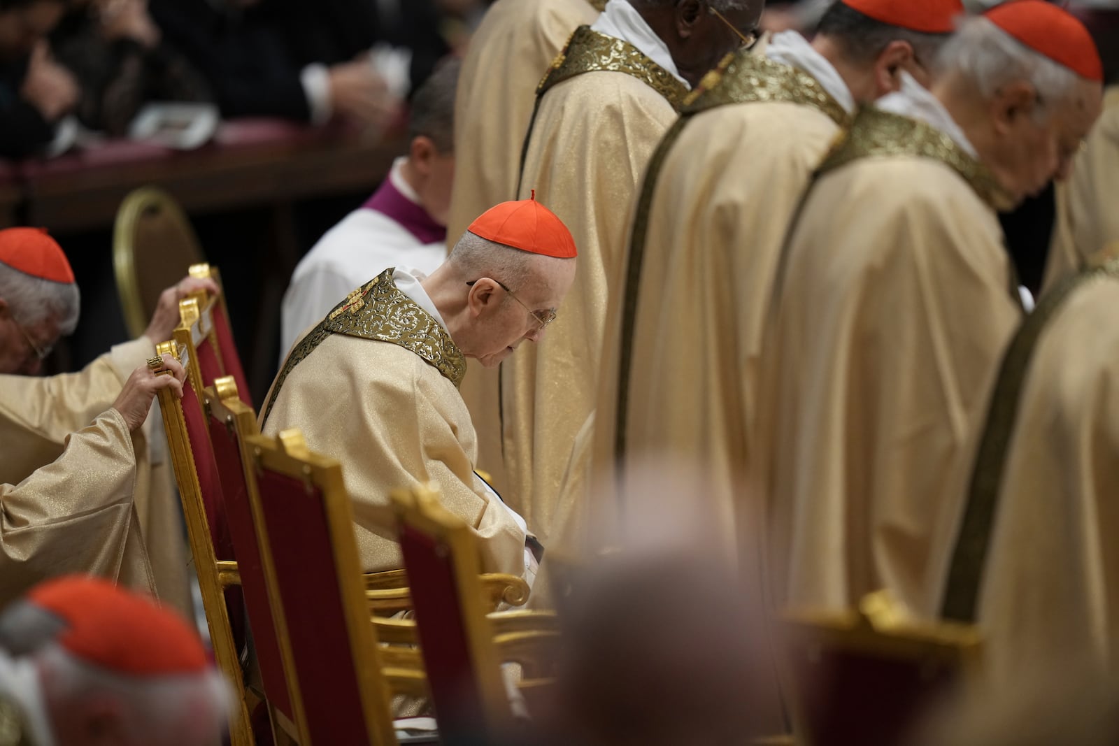 Cardinal Tarcisio Bertone follows Pope Francis presiding over the Christmas Eve Mass in St. Peter's Basilica at The Vatican, Tuesday, Dec. 24, 2024, after opening the basilica's holy door marking the start of the Catholic jubilar year 2025. (AP Photo/Andrew Medichini)