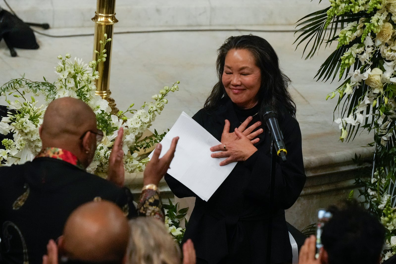 Suzanne Koga speaks during a ceremony in celebration of Roberta Flack's life at The Abyssinian Baptist Church on Monday, March 10, 2025, in New York. (AP Photo/Richard Drew)