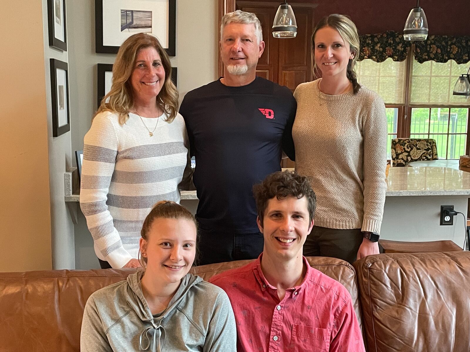 The Sigman family behind the Play 4 Payne Foundation, including Payne Sigman (front right), who suffered a traumatic brain injury following a car accident in January of 2014; his wife, Bridgett (front left); Payne's mother, Jenness (back left); his father, Mark (middle back), and sister, Shelby (Sigman) Herlihy. SAMANTHA WILDOW\STAFF