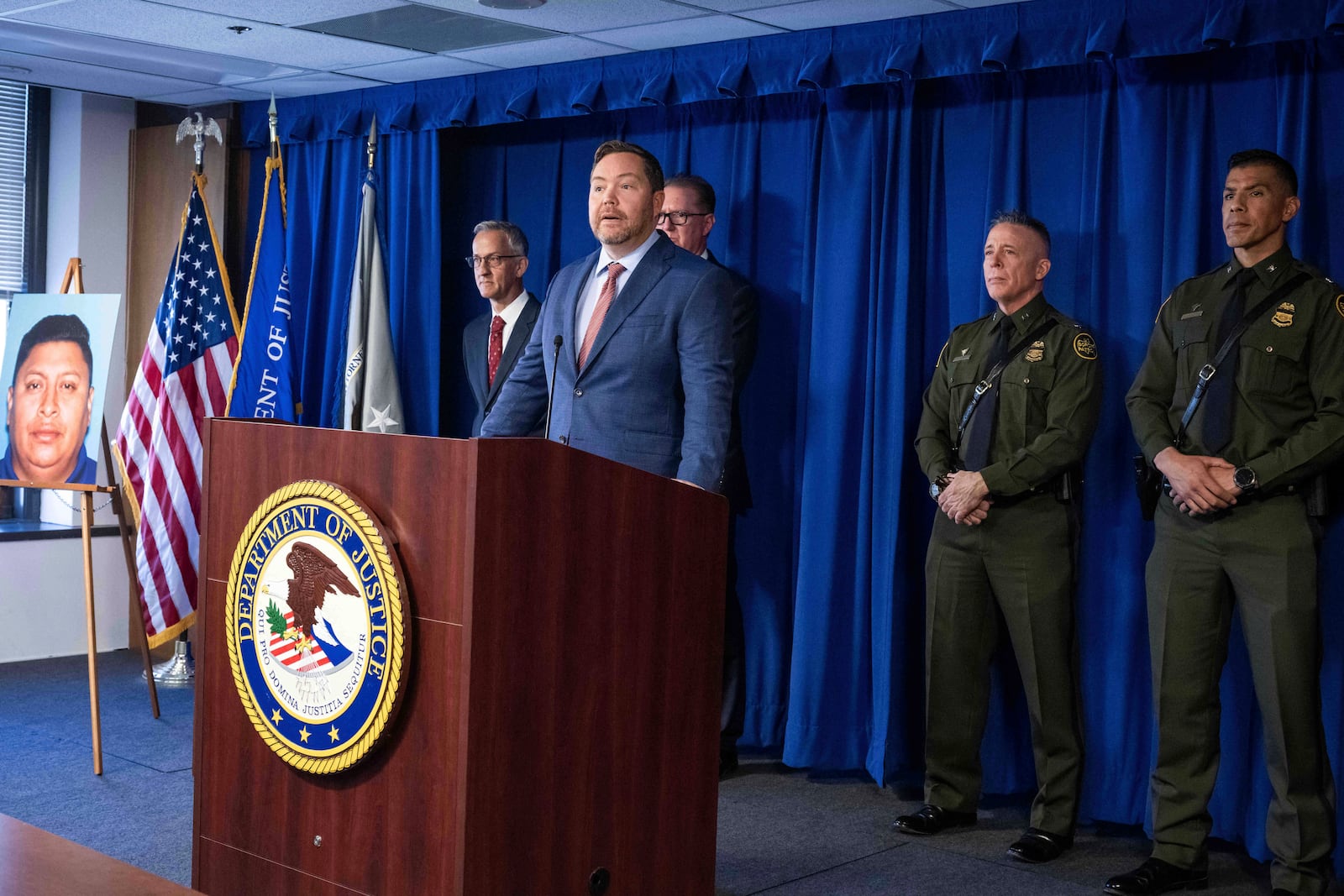 Acting United States Attorney Joe McNally, of the Central District of California, announces arrests of a transnational criminal organization that smuggled approximately 20,000 immigrants from Guatemala to the United States over five years on Monday, March 3, 2025, in Los Angeles. They are looking for Helmer Obispo-Hernandez pictured at left. (Sarah Reingewirtz/The Orange County Register via AP)