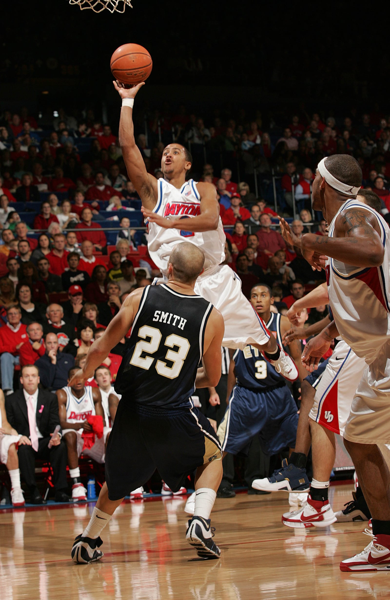 Dayton's Brian Roberts floats a shot over Mike Smith of East Tennessee State University on Nov. 10, 2007. PHOTO ERIK SCHELKUN