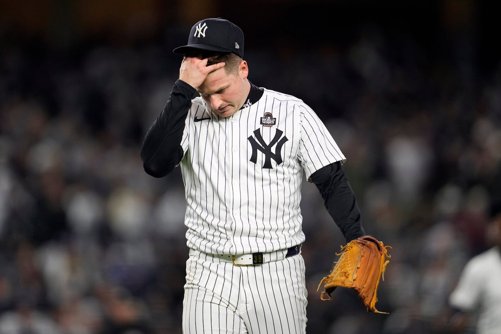 New York Yankees starting pitcher Clarke Schmidt walks back to the dugout after throwing against the Los Angeles Dodgers during the second inning in Game 3 of the baseball World Series, Monday, Oct. 28, 2024, in New York. (AP Photo/Godofredo A. Vásquez)