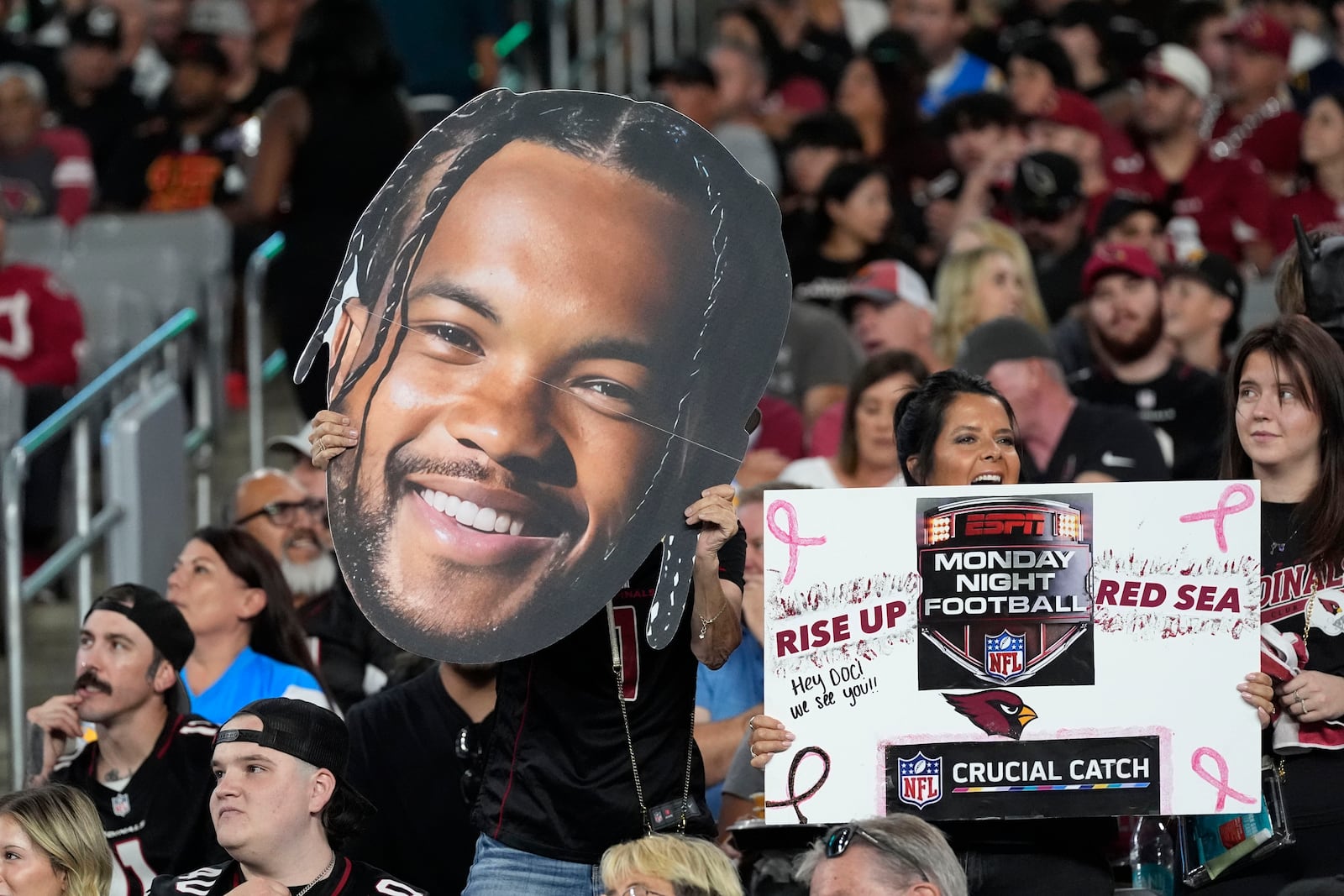 Fans cheer during the first half of an NFL football game between the Arizona Cardinals and the Los Angeles Chargers, Monday, Oct. 21, 2024, in Glendale Ariz. (AP Photo/Ross D. Franklin)