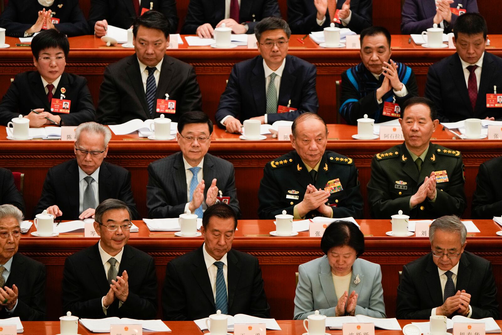 Delegates react during the opening session of the National People's Congress (NPC) at the Great Hall of the People in Beijing, China, Wednesday, March 5, 2025. (AP Photo/Ng Han Guan)