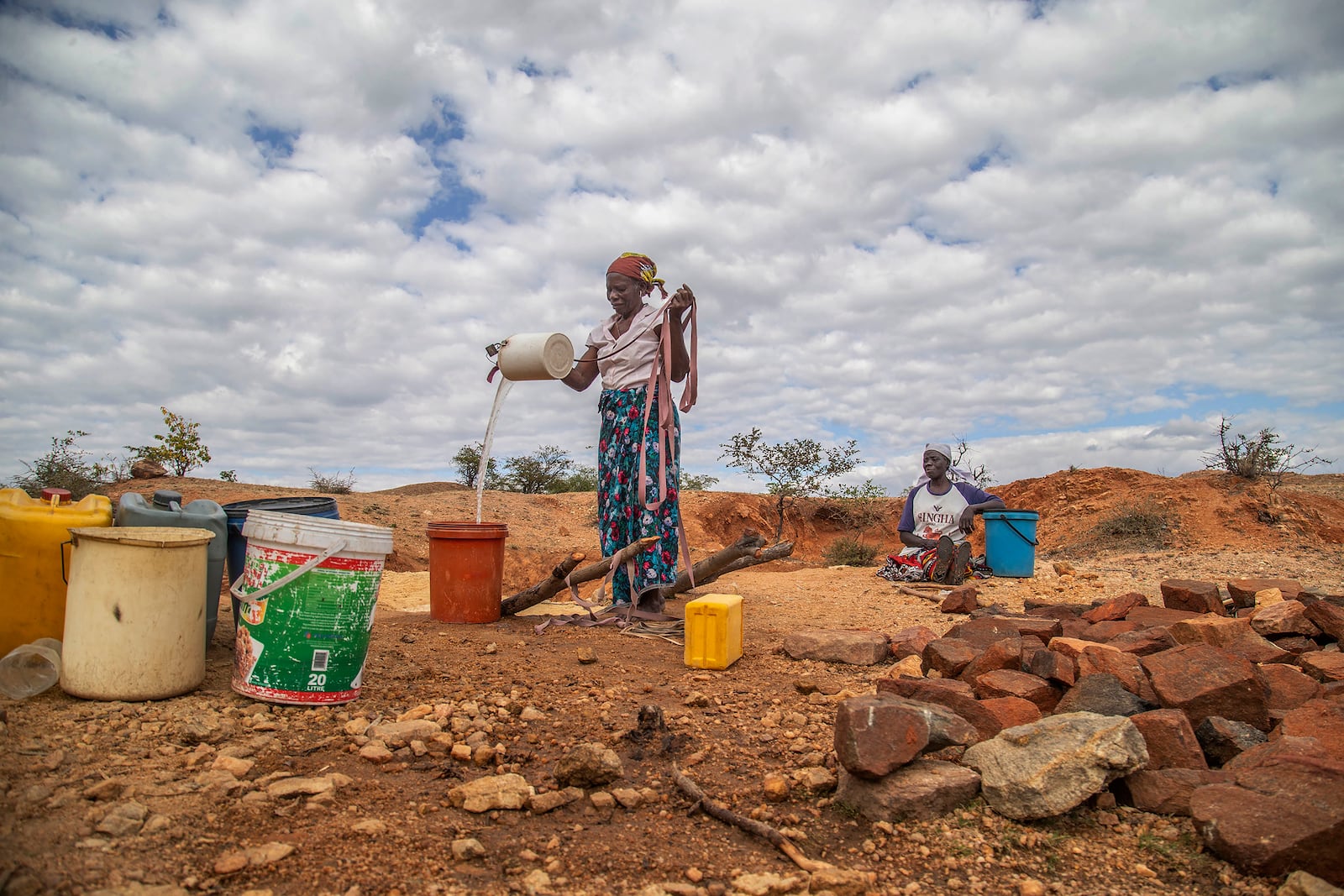 FILE - Villagers fetch water from a makeshift borehole in Mudzi, Zimbabwe, July 2, 2024. (AP Photo/Aaron Ufumeli, File)