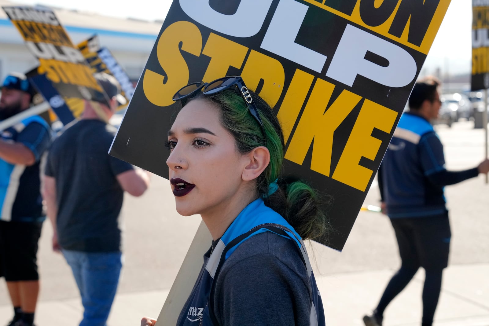 Amazon employee Gabriela Bautista joins other workers during a strike outside the gates of an Amazon Fulfillment Center on Friday, Dec. 20, 2024, in City of Industry, Calif. (AP Photo/Damian Dovarganes)