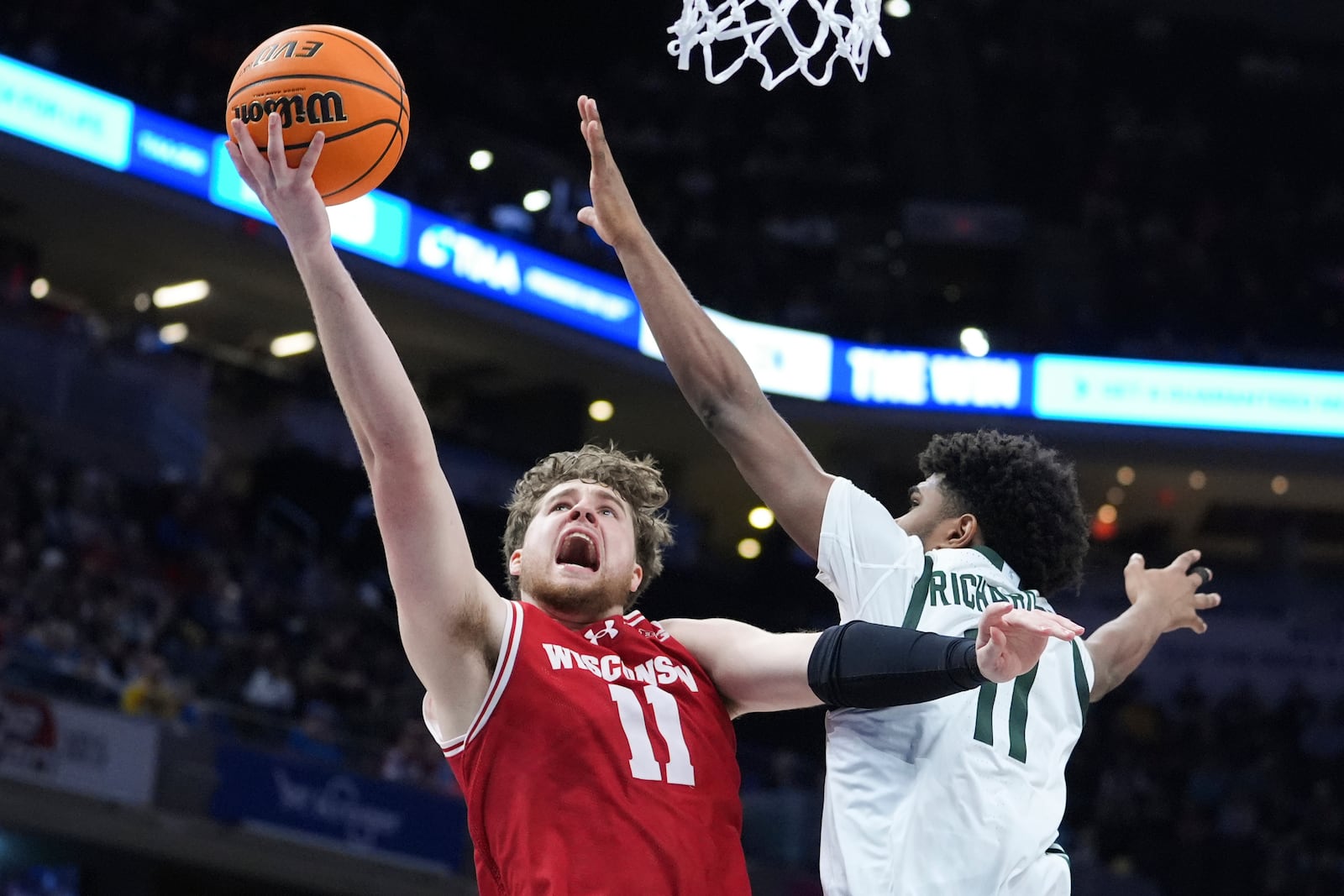 Wisconsin guard Max Klesmit (11) drives on Michigan State guard Jase Richardson (11) during the second half of an NCAA college basketball game in the semifinals of the Big Ten Conference tournament in Indianapolis, Saturday, March 15, 2025. (AP Photo/Michael Conroy)