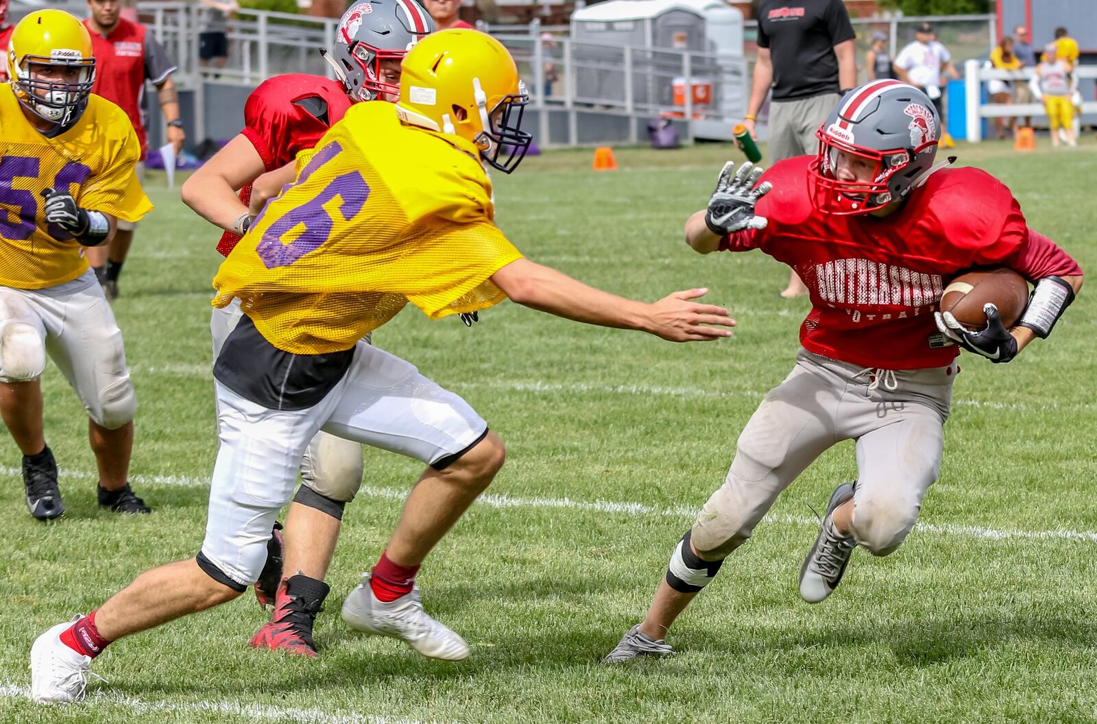 Southeastern High School senior wide receiver Austin Sanders tries to elude a Greenfield McClain defender during a five-team scrimmage on Saturday morning in South Charleston. CONTRIBUTED PHOTO BY MICHAEL COOPER