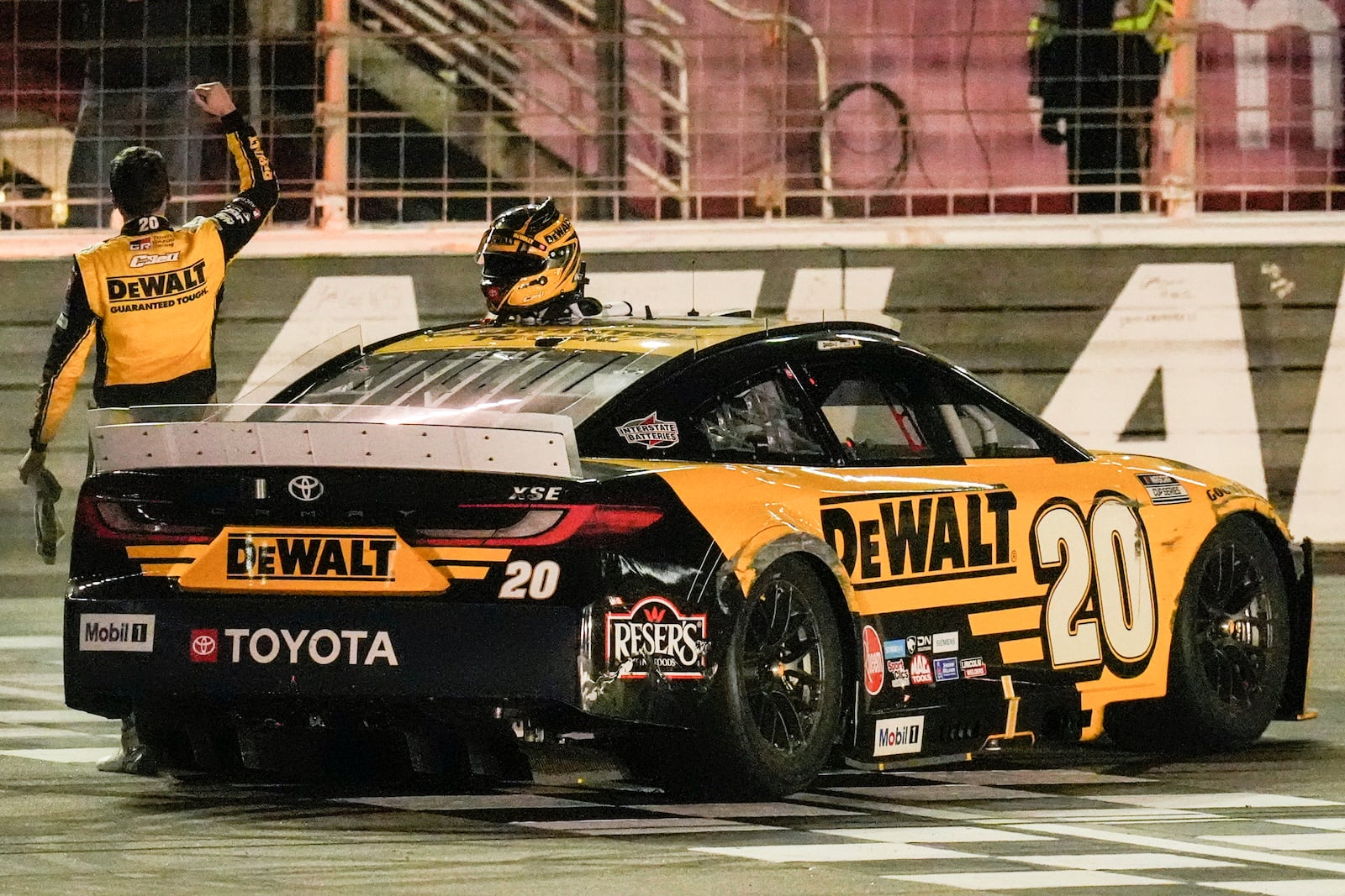 Christopher Bell (20) celebrates his victory after a NASCAR Cup Series auto race, Sunday, Feb. 23, 2025, in Hampton, Ga. (AP Photo/Mike Stewart)