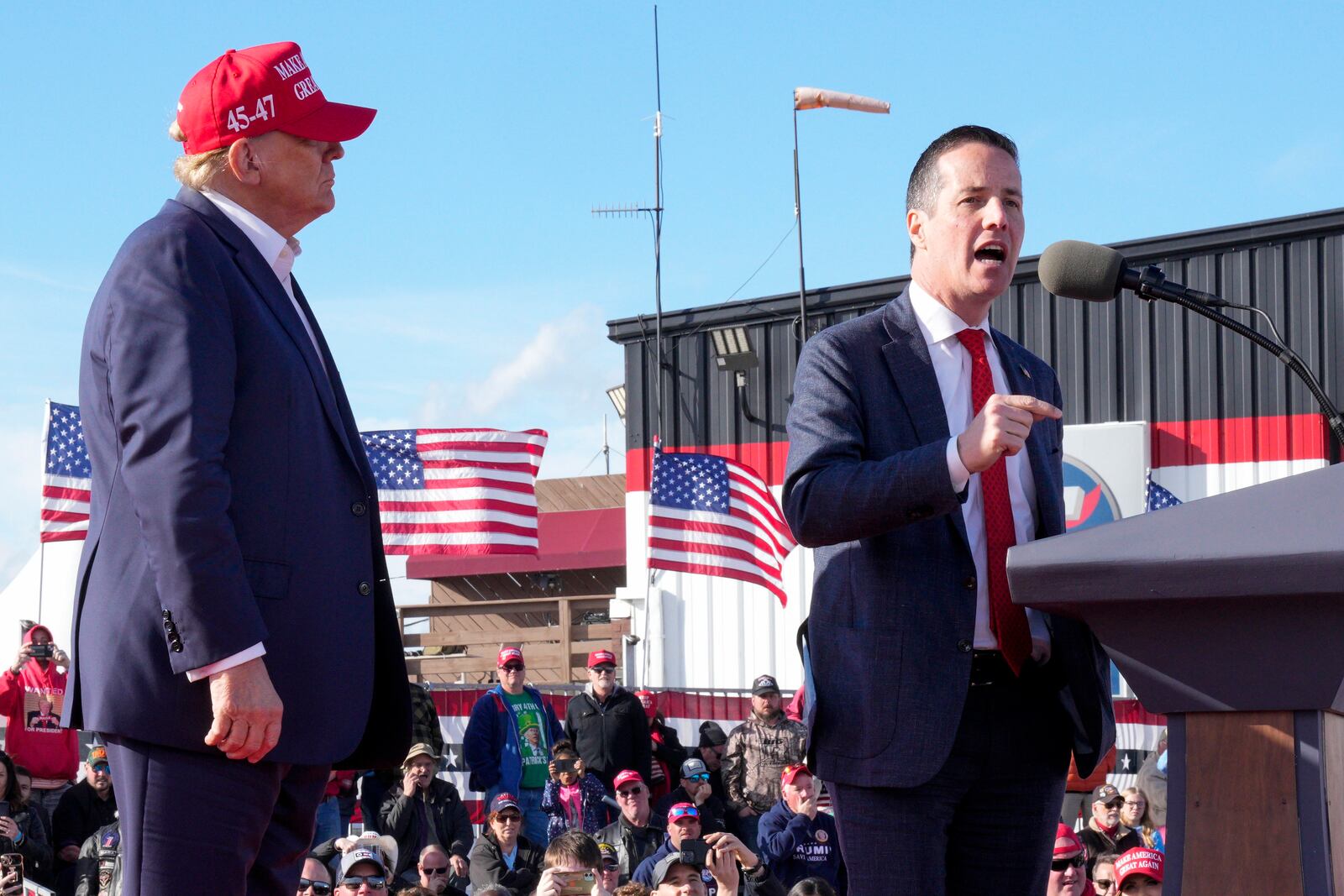 FILE - Republican presidential candidate and former President Donald Trump, left, listens as Senate candidate Bernie Moreno speaks at a campaign rally March 16, 2024, in Vandalia, Ohio. Five states will hold presidential primaries on Tuesday, March 19, as President Joe Biden and Trump continue to lock up support around the country after becoming their parties' presumptive nominees. Ohio's Republican Senate primary pits Trump-backed Moreno against two challengers, Ohio Secretary of State Frank Frank LaRose and Matt Dolan, whose family owns the Cleveland Guardians baseball team. (AP Photo/Jeff Dean, File)