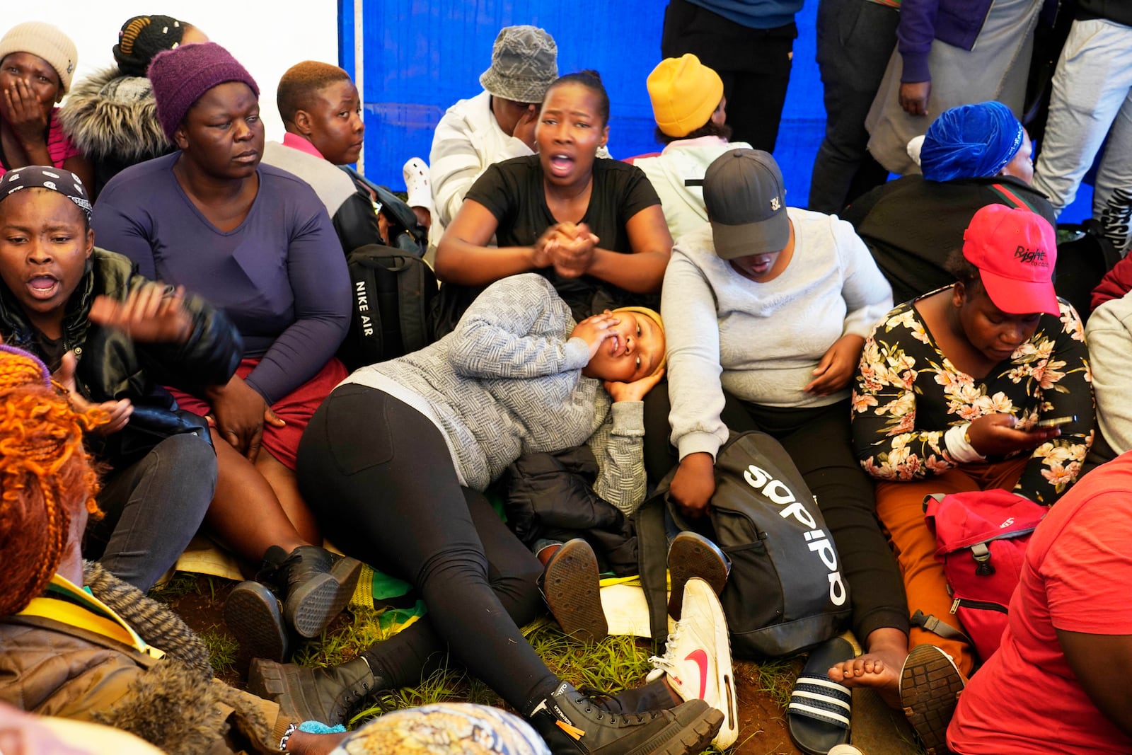 Relatives and friends wait for news near a reformed gold mineshaft where illegal miners are trapped in Stilfontein, South Africa, Friday, Nov. 15, 2024. (AP Photo/Denis Farrell)