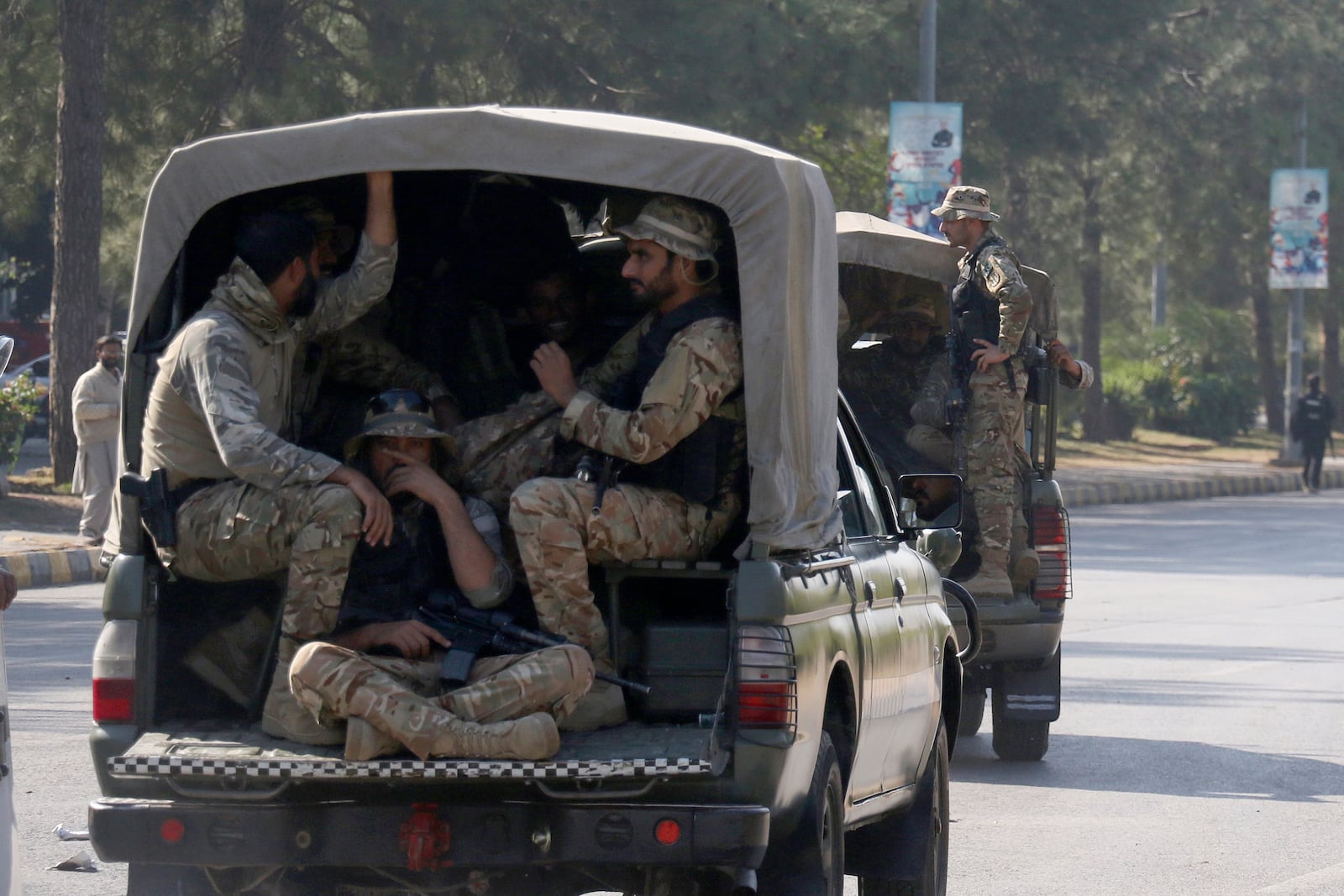 Pakistan's army troops move toward the Red Zone, which is an area that houses key government buildings, to take position ahead of the rally of supporters of imprisoned former premier Imran Khan's Pakistan Tehreek-e-Insaf party, in Islamabad, Pakistan, Tuesday, Nov. 26, 2024. (AP Photo/Ehsan Shahzad)