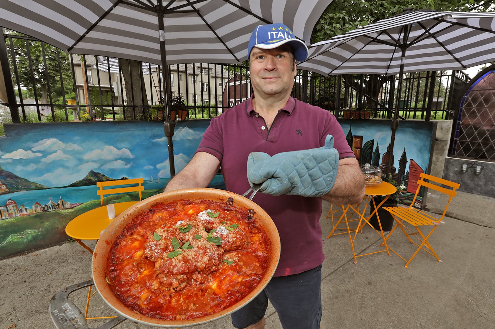 Tom Thompson, the owner and chef at Eatly, is shown with one of his ravioli and meatball dishes in the 2021 image. BILL LACKEY/STAFF 